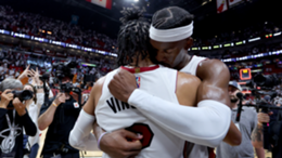 Jimmy Butler of the Miami Heat hugs teammate Gabe Vincent after defeating the Boston Celtics