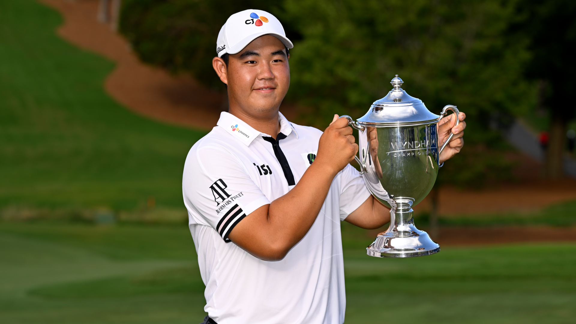 Kim Joo-hyung celebrates with the Wyndham Championship trophy