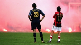 Inter's Marco Materazzi and Milan's Rui Costa look on as crowd trouble mars the teams' 2005 Champions League clash