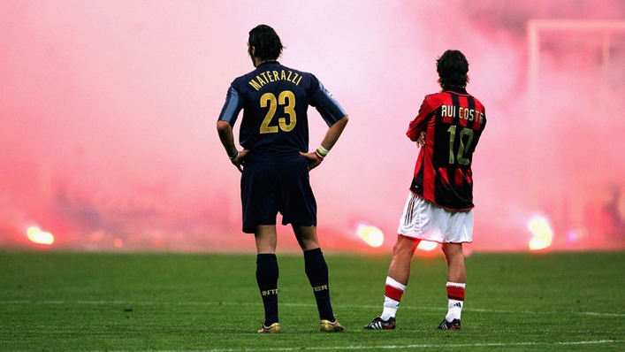 Inter's Marco Materazzi and Milan's Rui Costa look on as crowd trouble mars the teams' 2005 Champions League clash