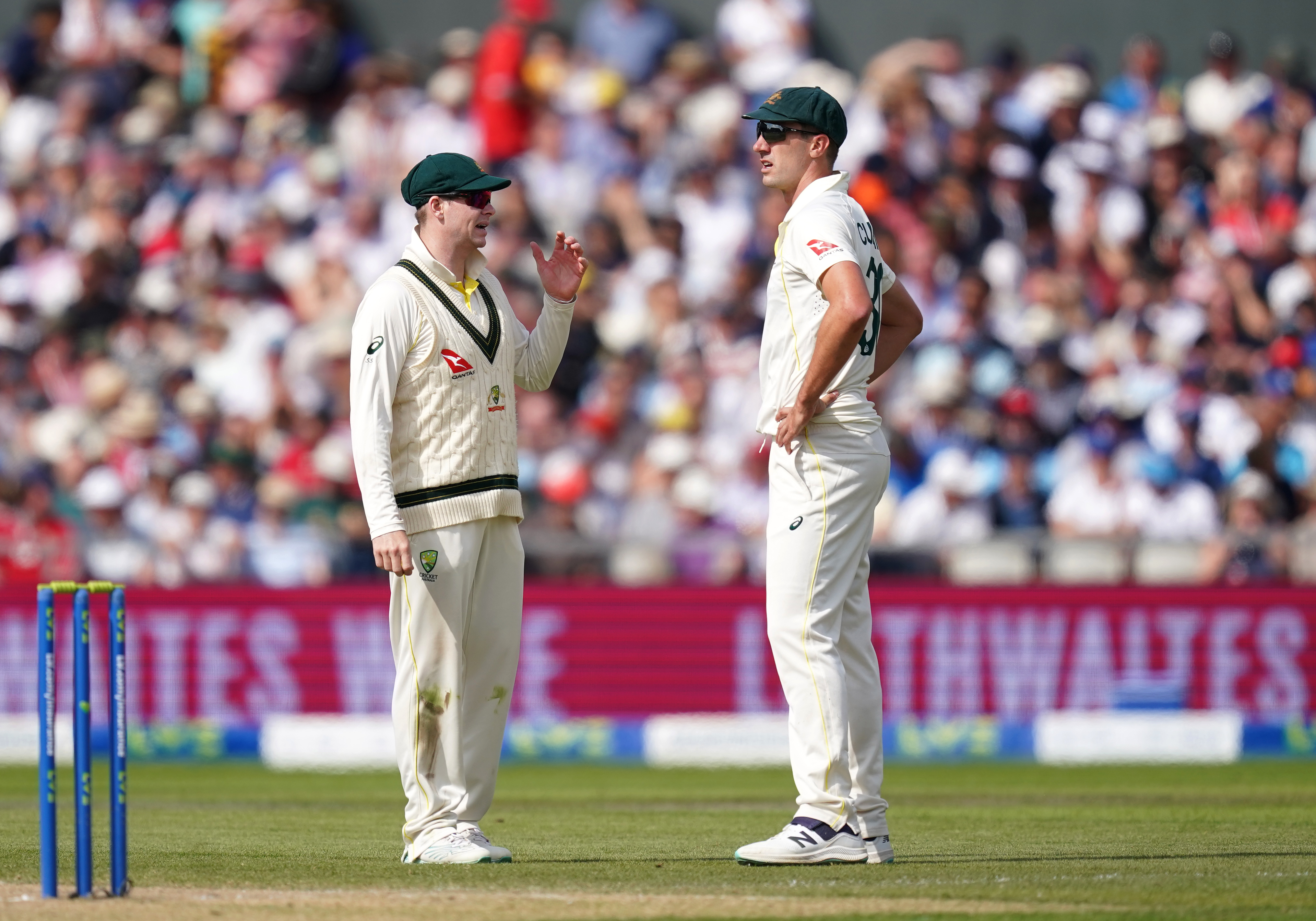 Pat Cummins, right, discusses tactics with Steve Smith