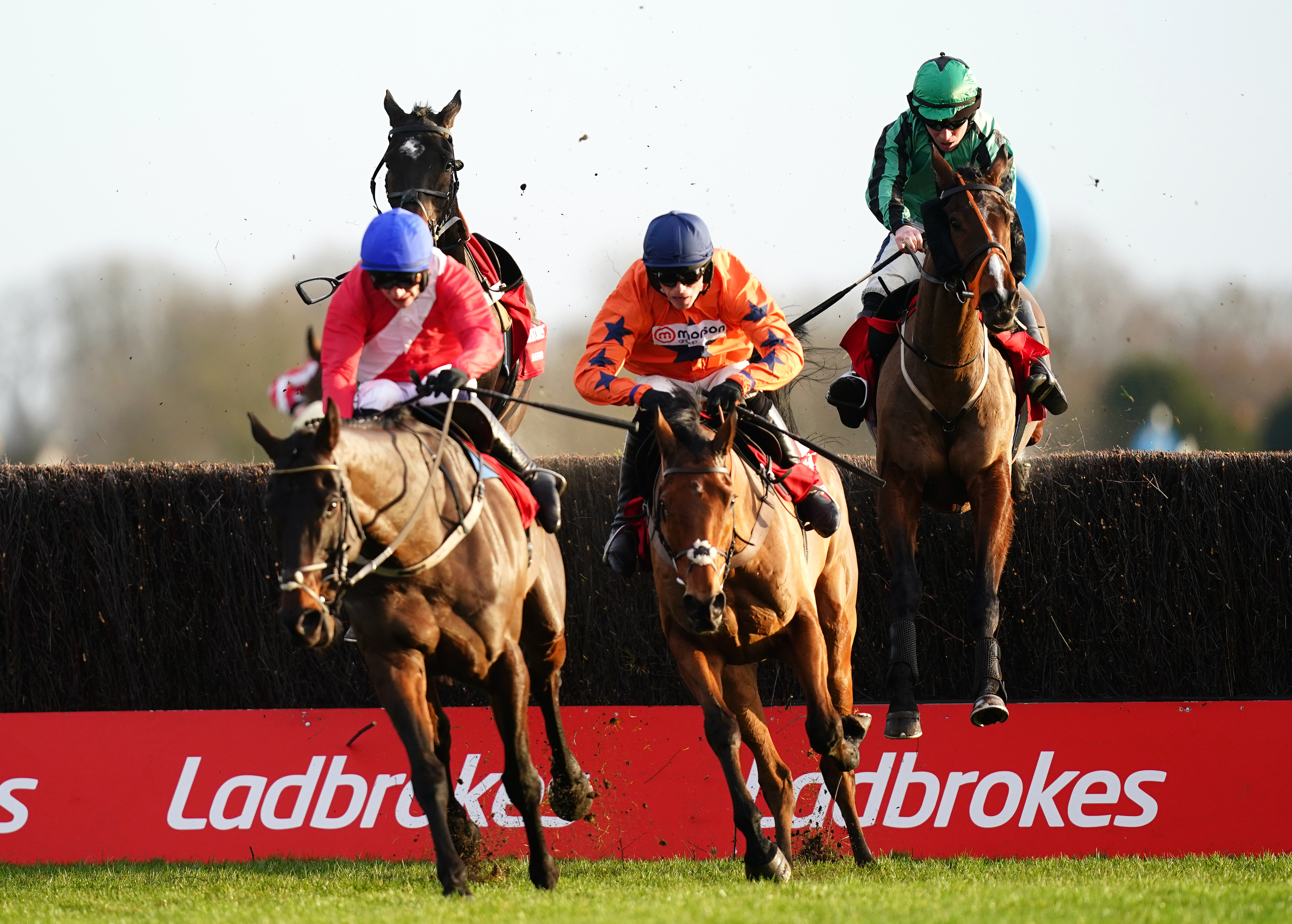 Hewick (right) still had plenty to do when jumping the last behind Allaho and Bravemansgame