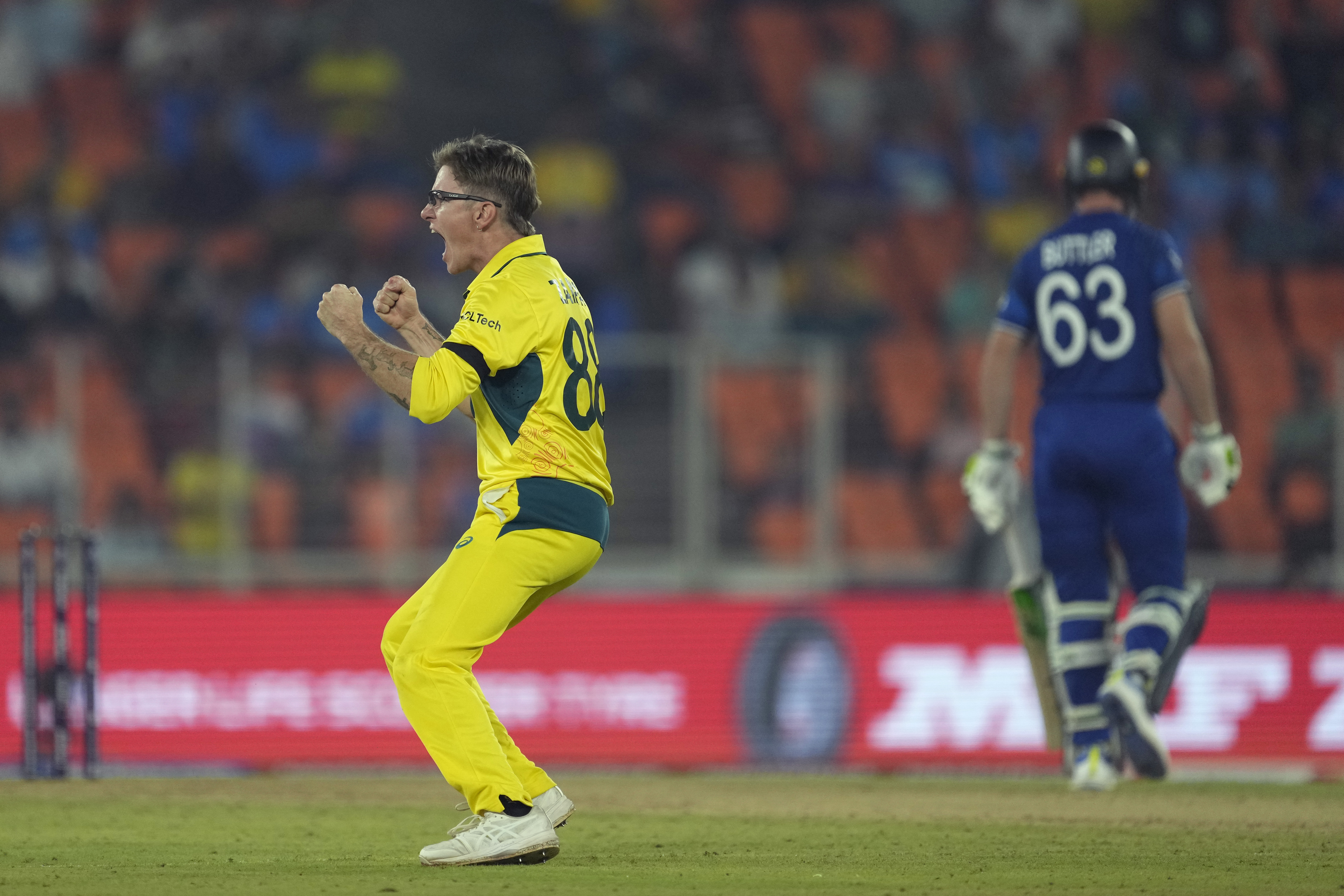 Australia's Adam Zampa celebrates the wicket of England captain Jos Buttler (Ajit Solanki/AP)