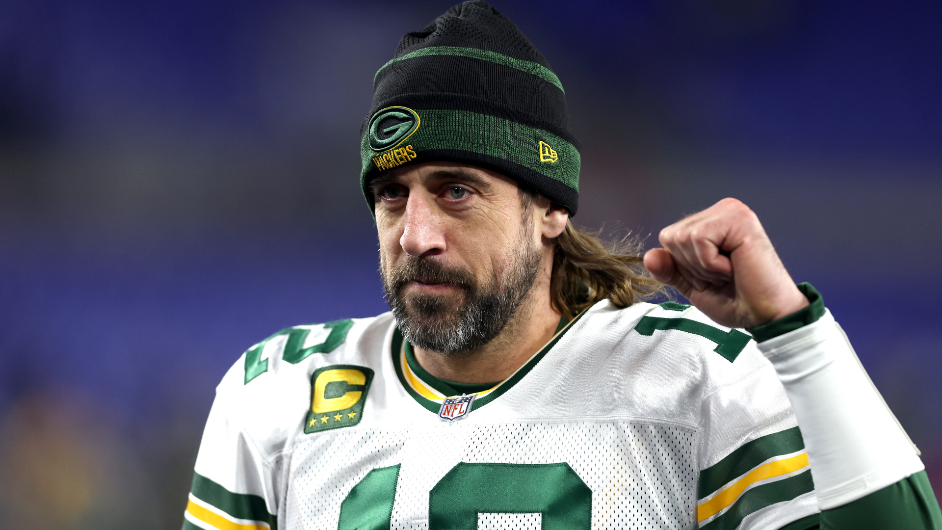 Quarterback Aaron Rodgers of the Green Bay Packers celebrates while running off the field after the Packers defeated the Baltimore Ravens