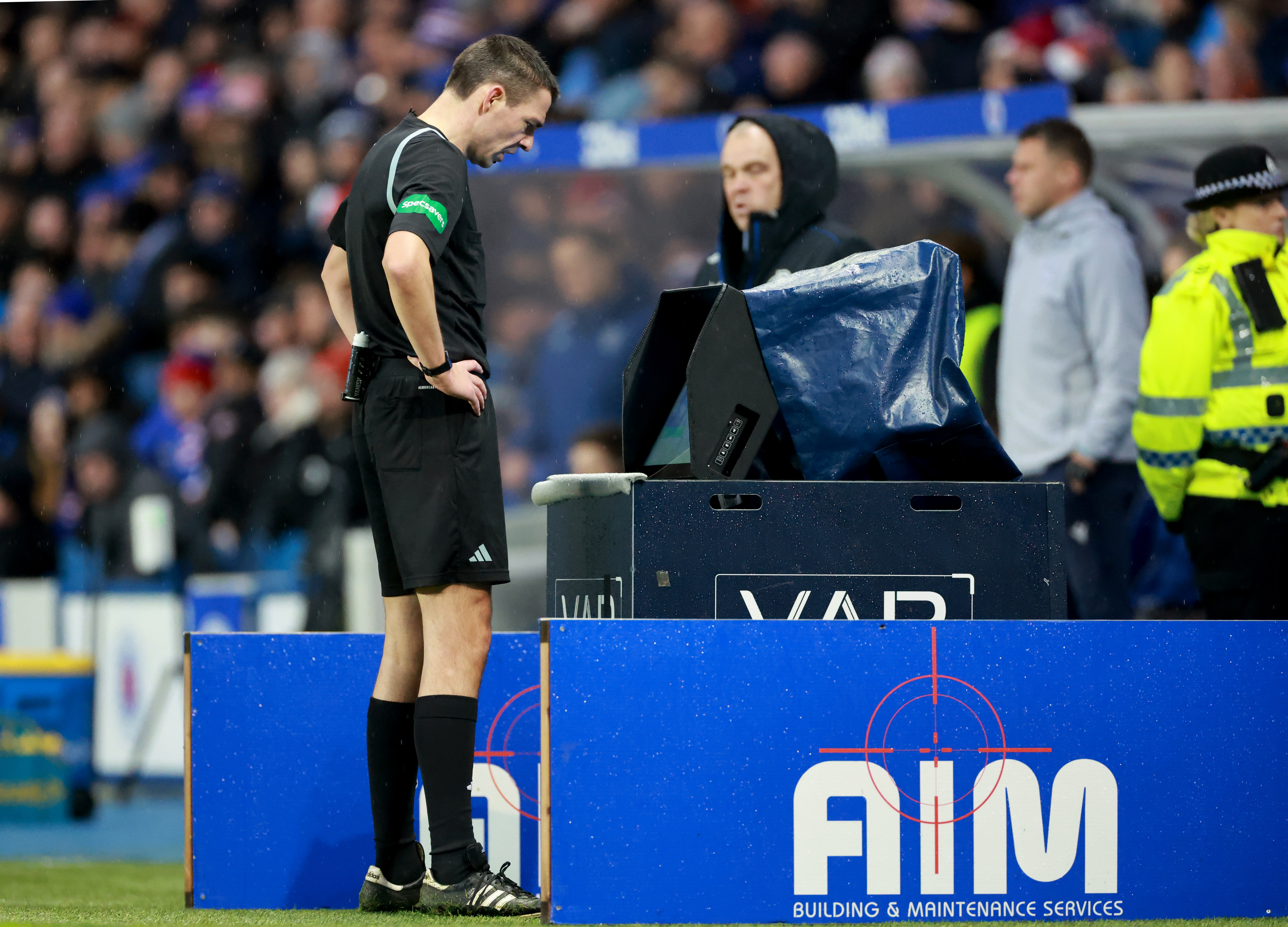 Referee Kevin Clancy views a replay before sending off Rangers’ Jose Cifuentes