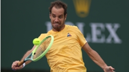 Richard Gasquet fights off a body serve with a backhand return