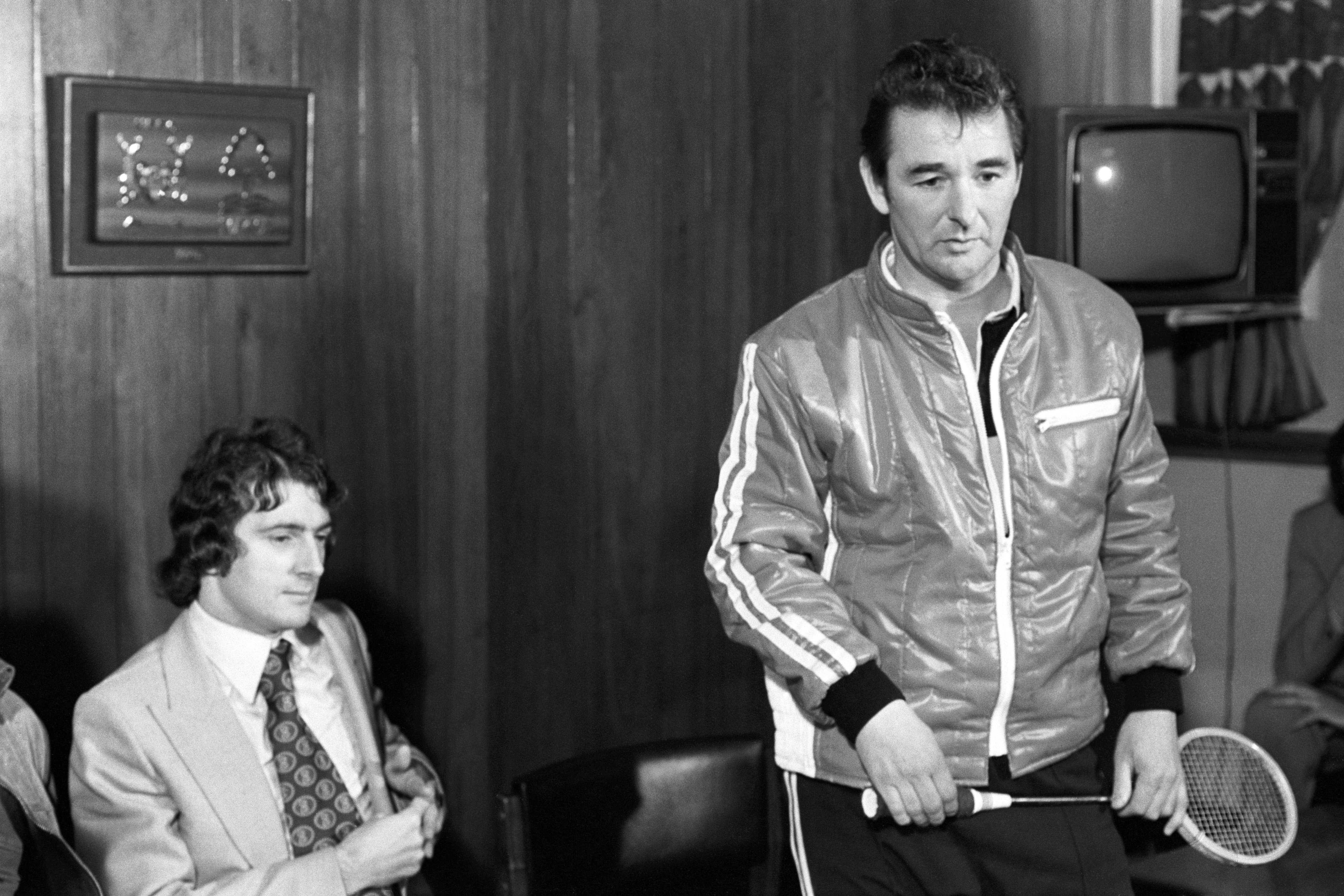 Clough (right) presented Francis to the media holding a squash racket