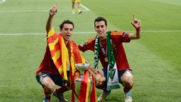 Xavi and Sergio Busquets celebrate after winning Euro 2012 with Spain