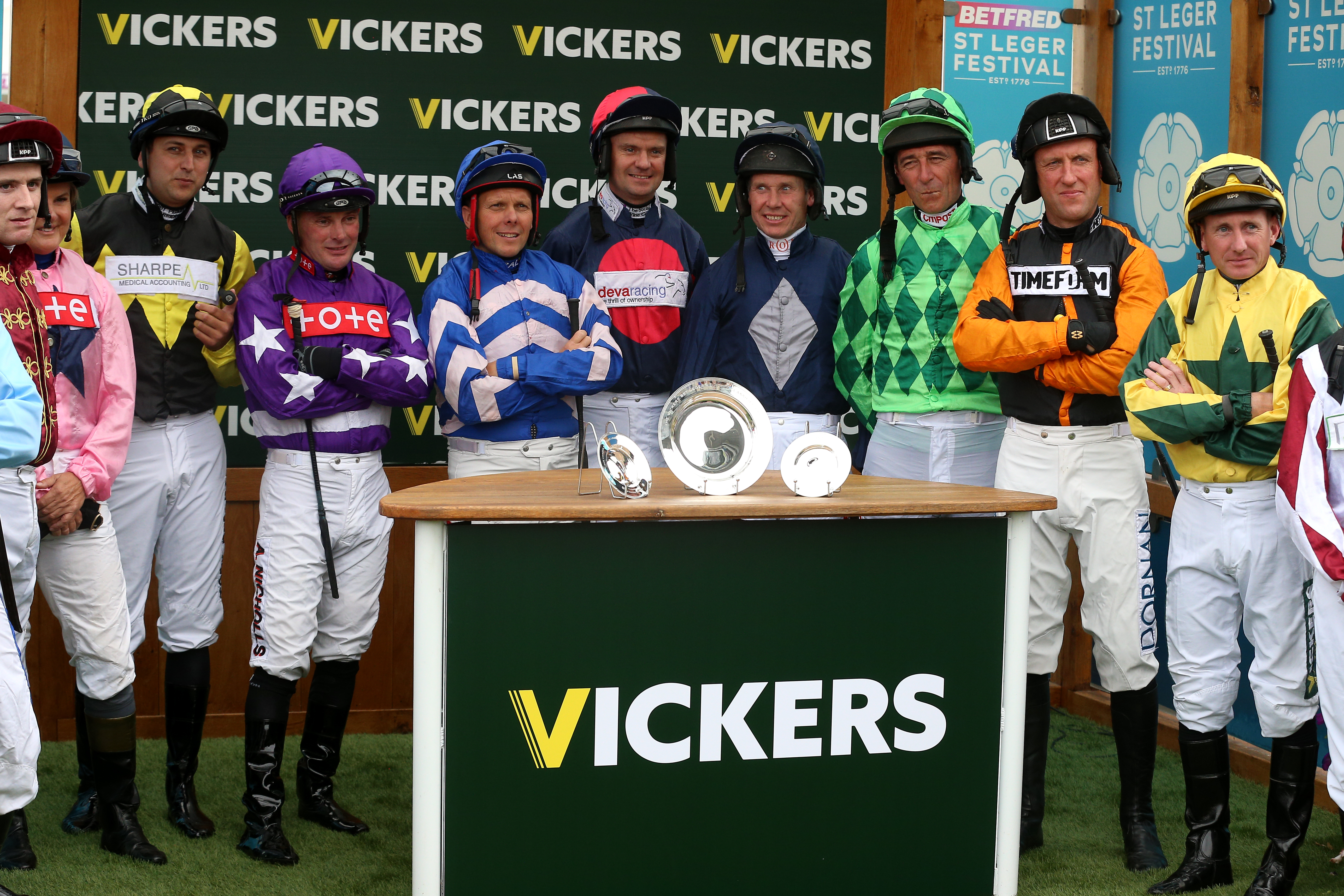 Retired jockeys line up before the Vickers.Bet Leger Legends Classified Stakes