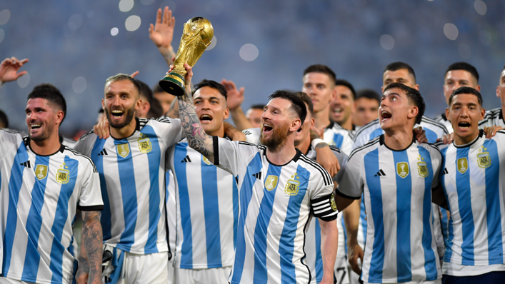 Lionel Messi and his Argentina teammates celebrate with the World Cup trophy after a friendly against Curaçao