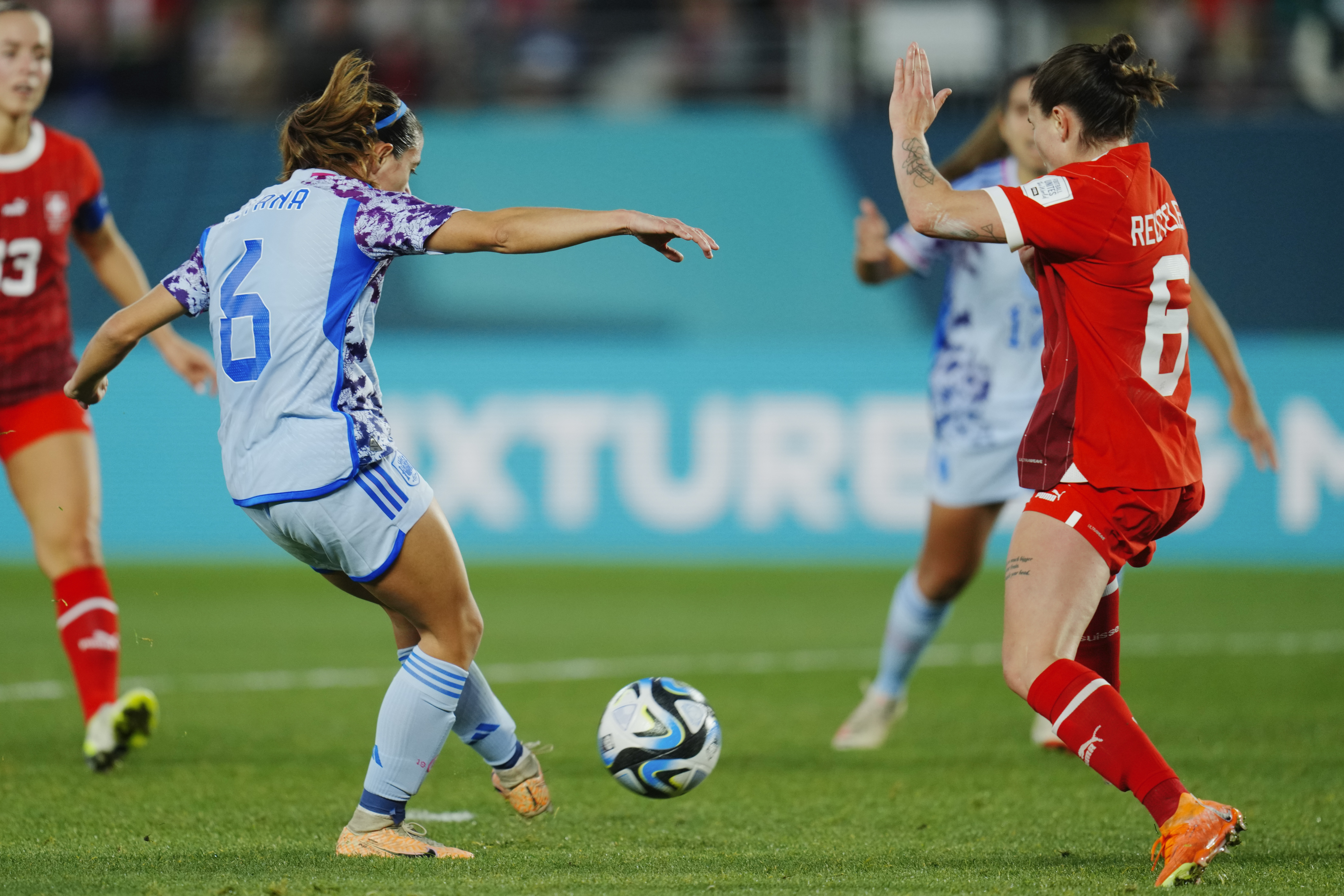 Spain’s Aitana Bonmati, left, scores against Switzerland