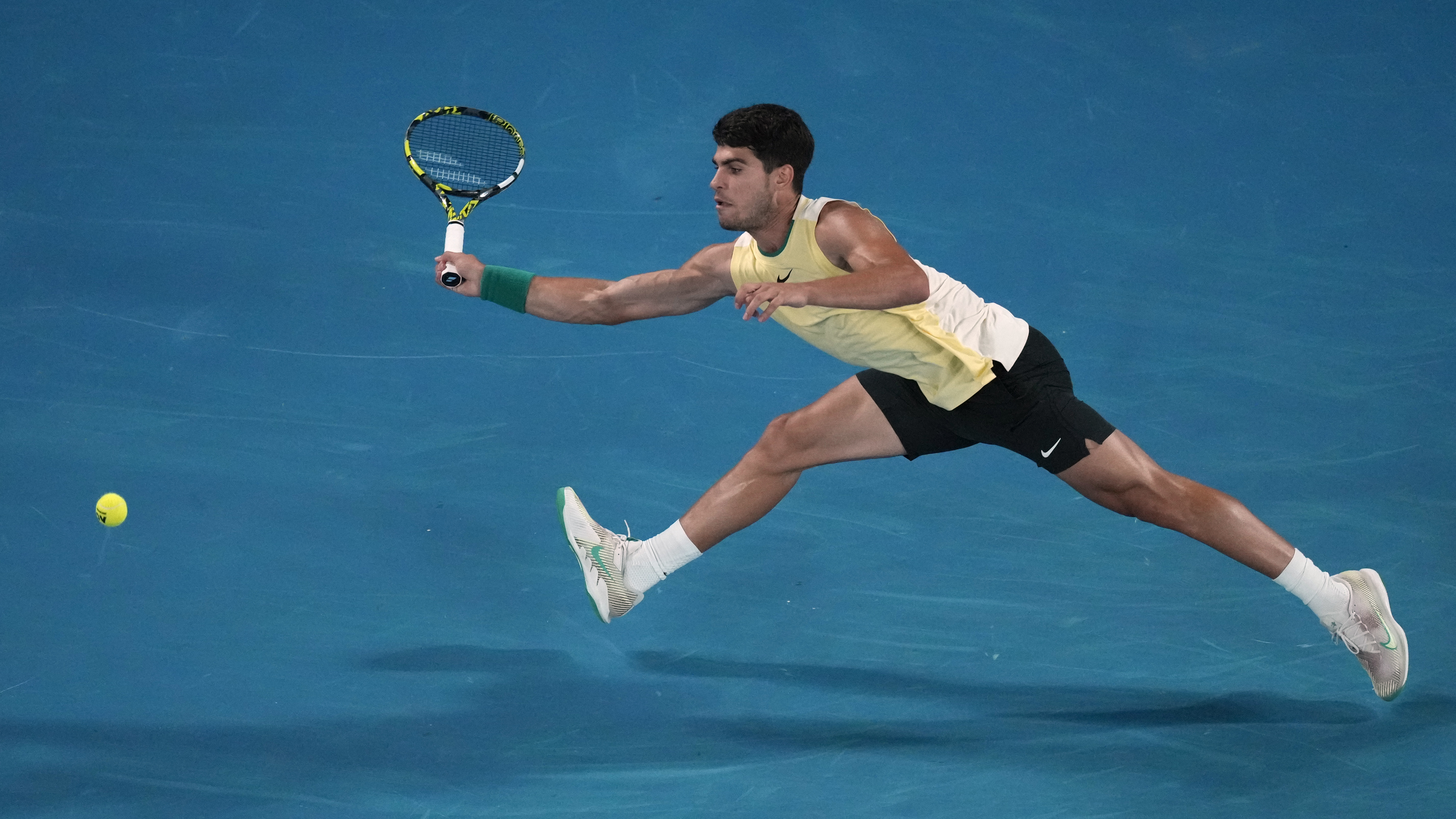 Carlos Alcaraz stretches for a forehand