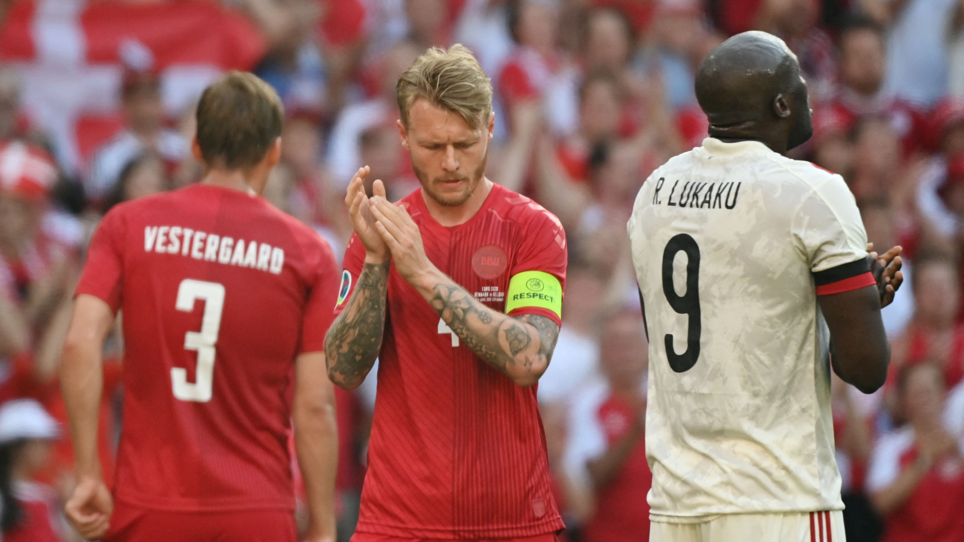 Jannik Vestergaard, Simon Kjaer and Romelu Lukaku (L-R) paused to applaud the absent Christian Eriksen