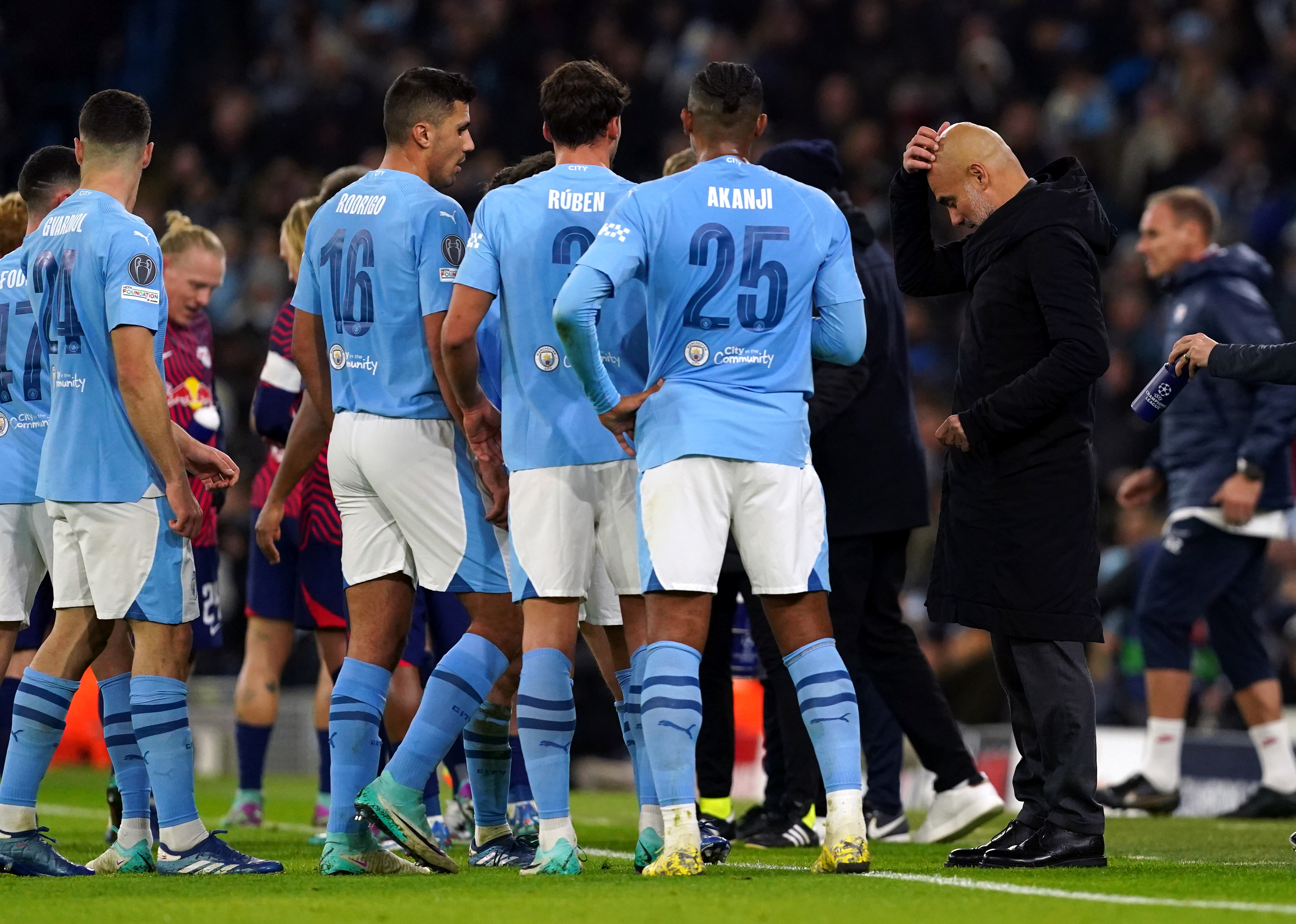 Pep Guardiola, right, talks to his players during Manchester City's win over RB Leipzig