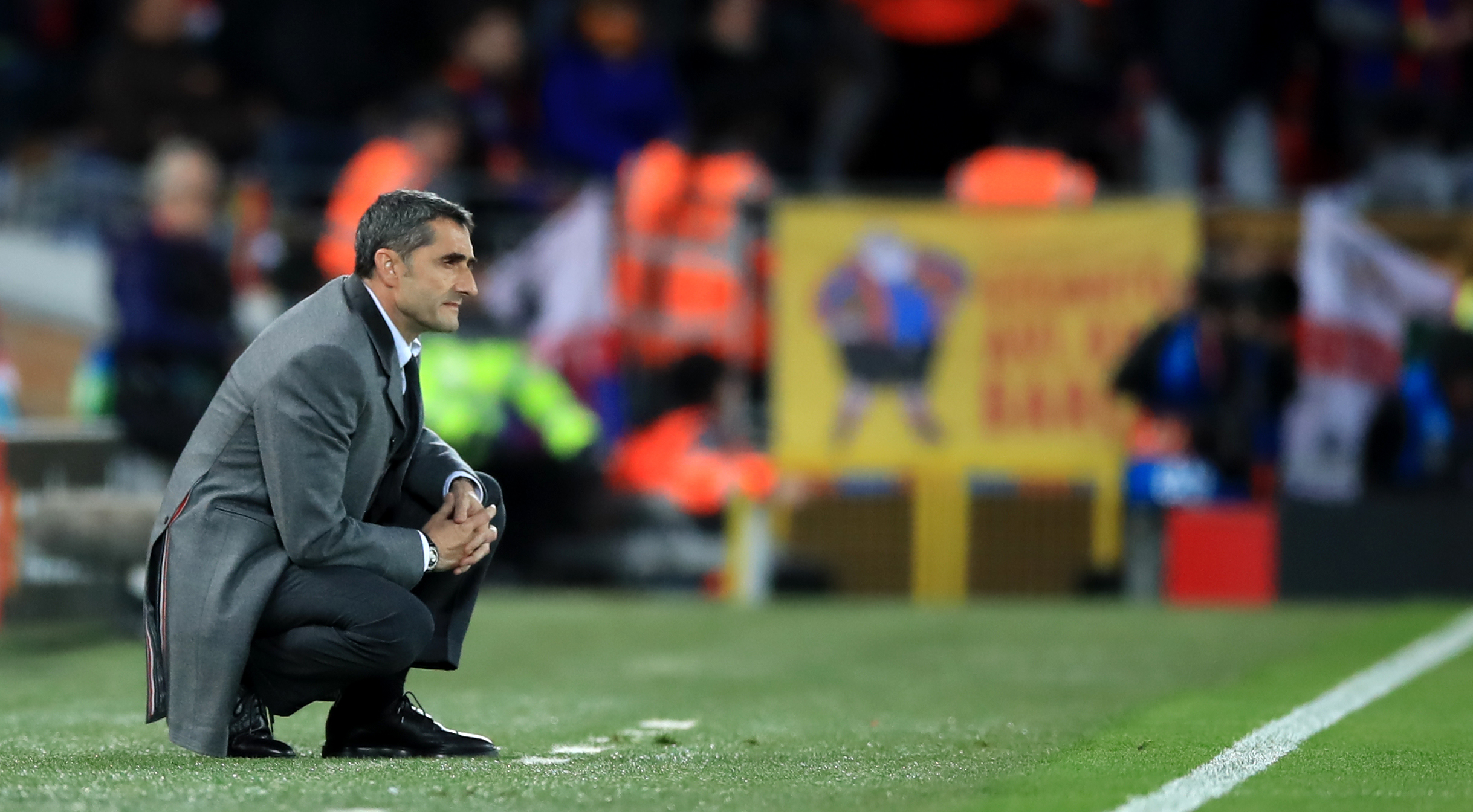 Athletic Bilbao coach Ernesto Valverde kneels in the technical area