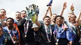 Plymouth manager Steven Schumacher, left of trophy, and his players celebrate winning the League One title (Nick Potts/PA)