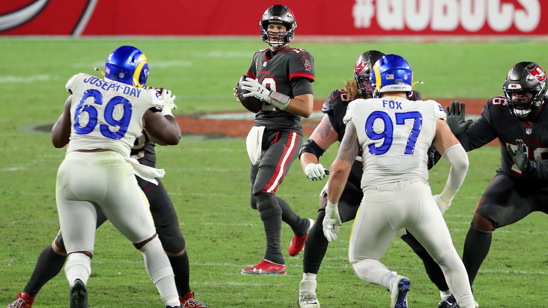 Tom Brady drops back to pass against the Rams