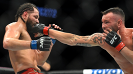 Colby Covington (R) connects with Jorge Masvidal in their welterweight fight during UFC 272