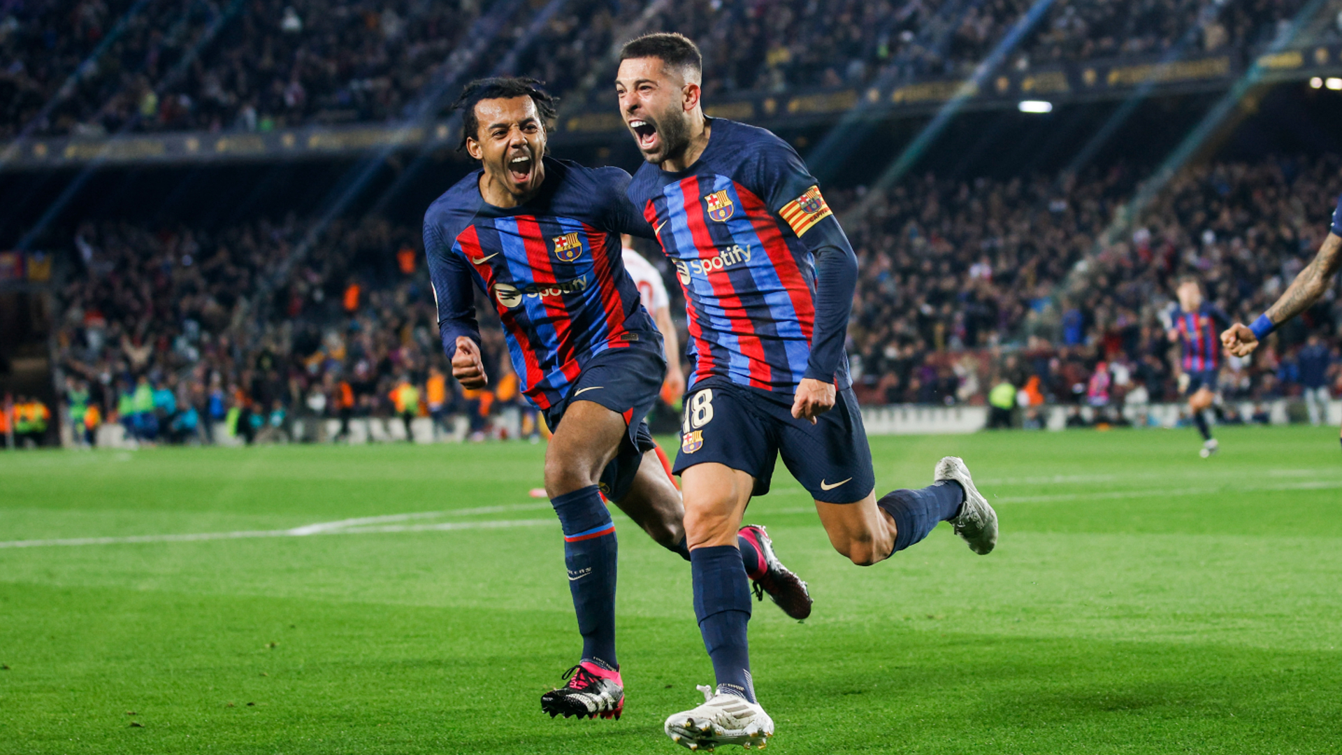 Jules Kounde (L) celebrates with Jordi Alba against Sevilla