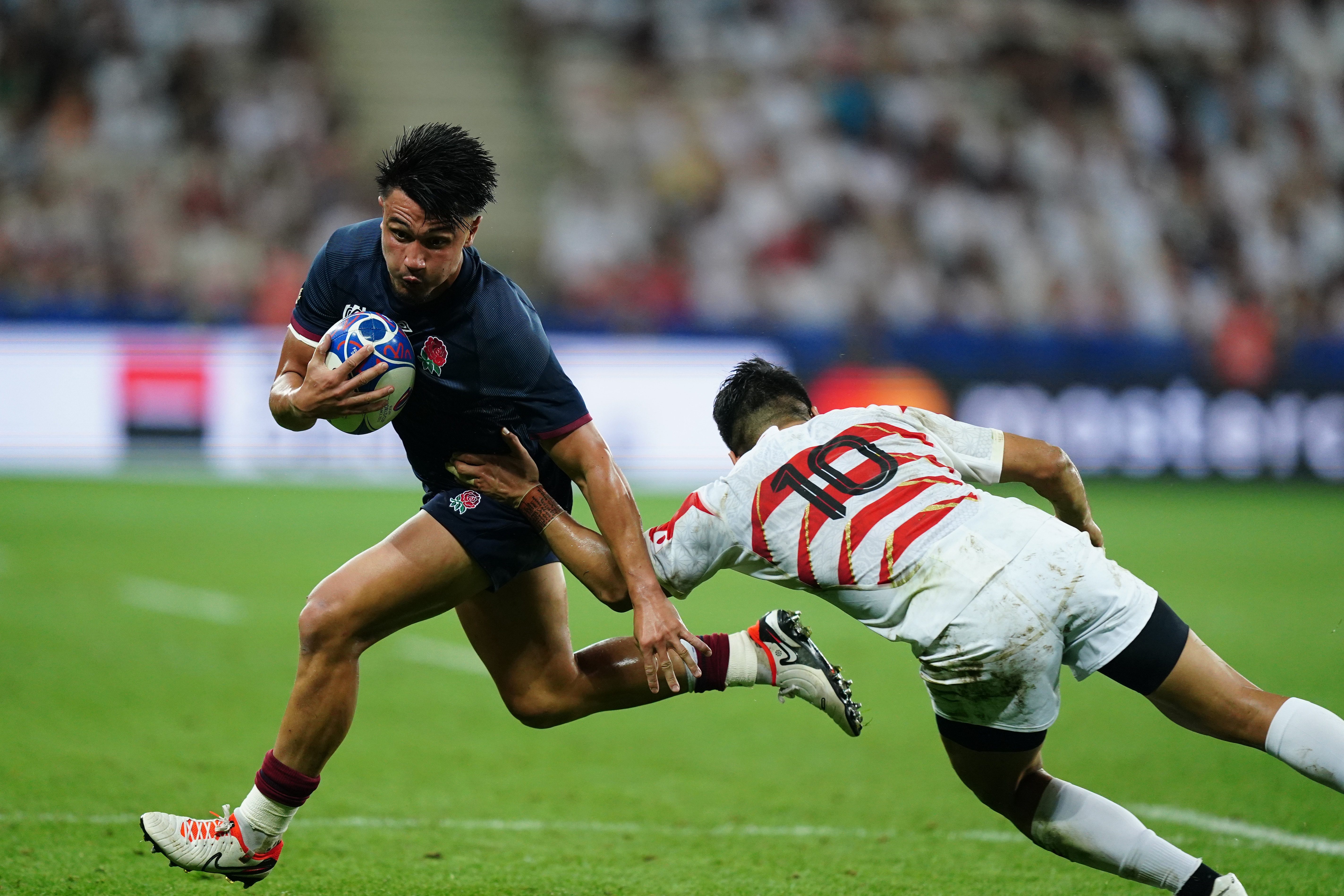 England’s Marcus Smith (left) gets away from Japan’s Rikiya Matsuda