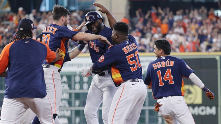 Yordan Alvarez is mobbed by his teammates after his game-winning hit in extra innings