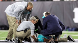 Tua Tagovailoa being assisted by Miami Dolphins medical staff after his scary injury