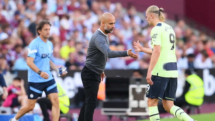Pep Guardiola (C) shakes Erling Haaland's hand as he comes off for Manchester City against West Ham
