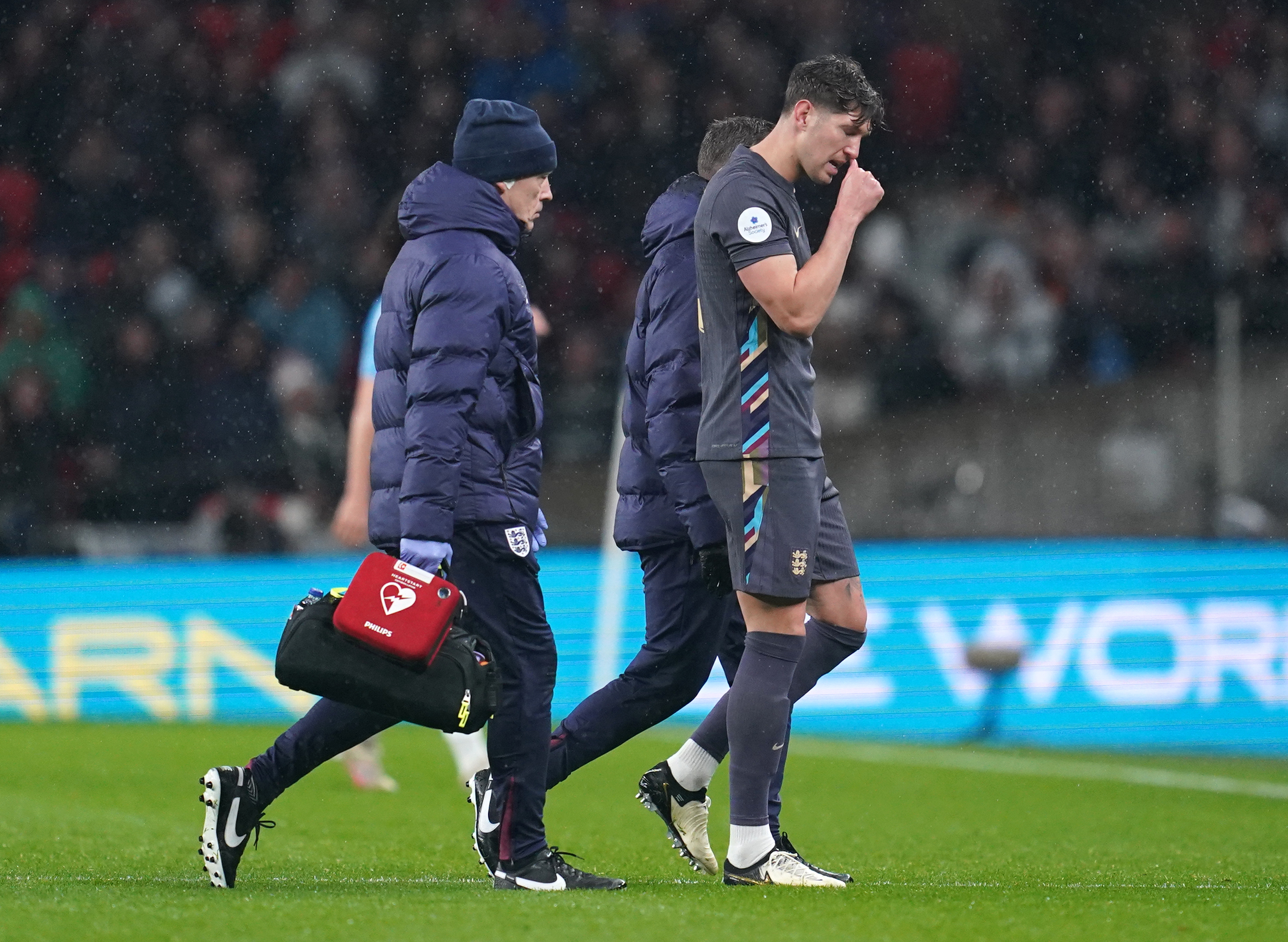 England’s John Stones leaves the pitch with an injury early on against Belgium