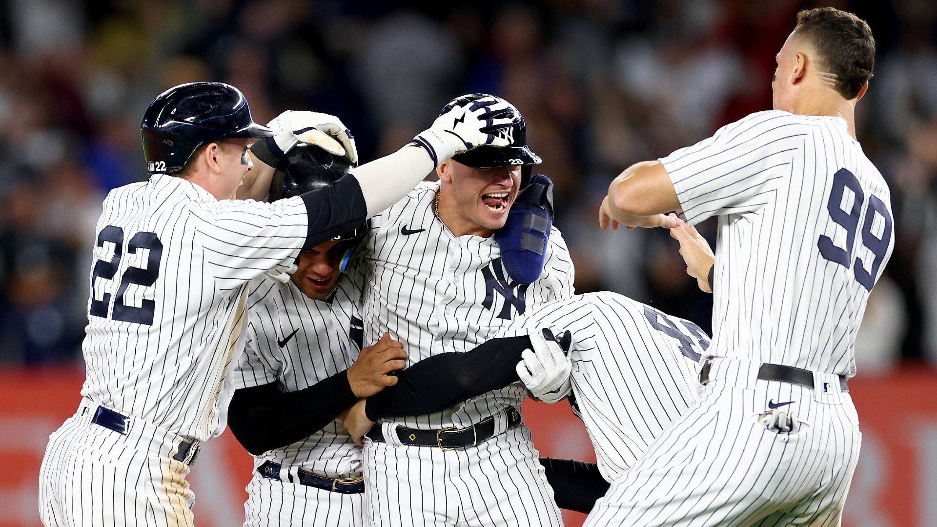 Josh Donaldson of the New York Yankees is congratulated by Harrison Bader, Gleyber Torres, Anthony Rizzo and Aaron Judge after driving in the game-winning run