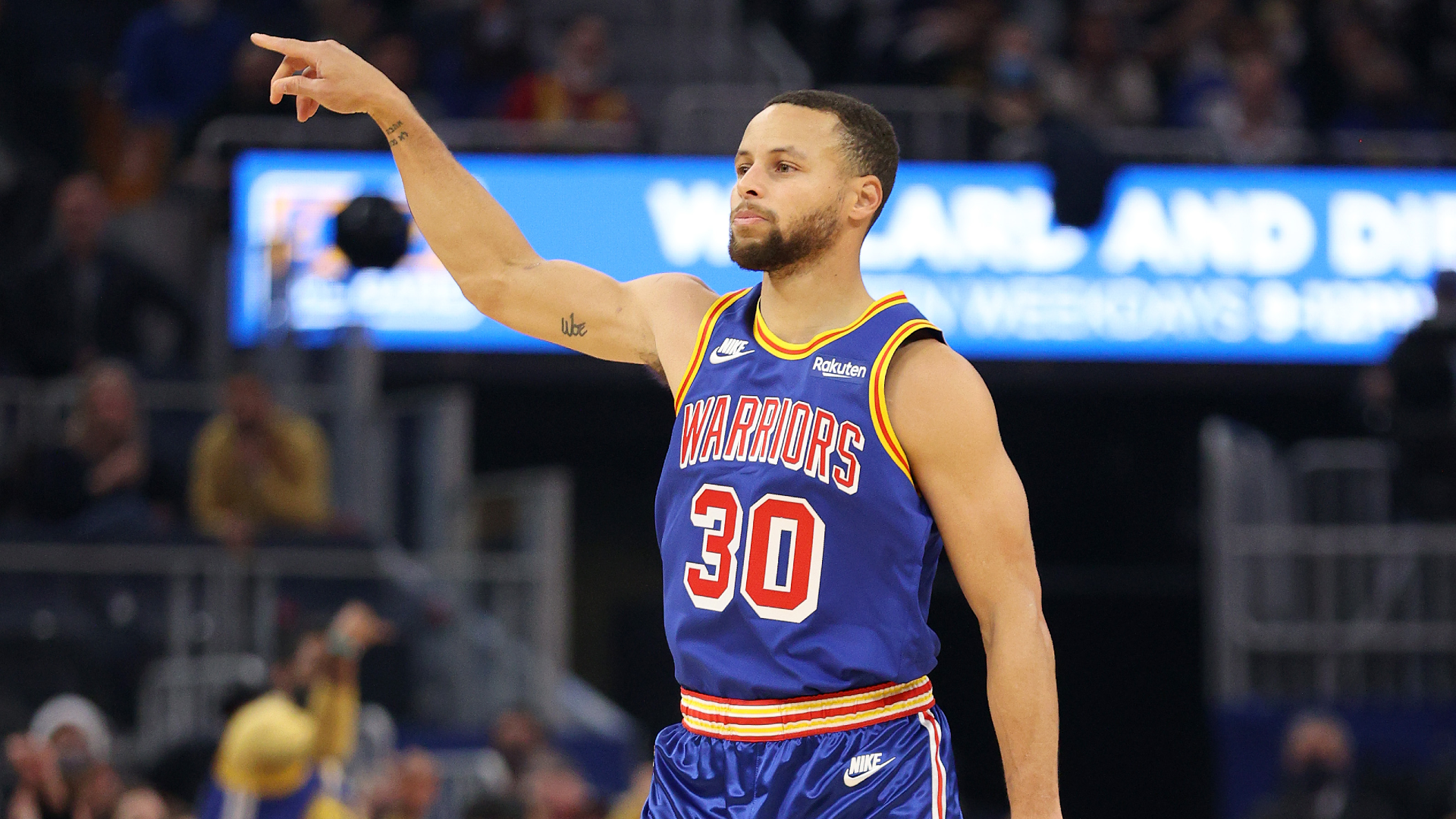 Stephen Curry of the Golden State Warriors reacts after making a three-point basket against the Phoenix Suns in the first half at Chase Center