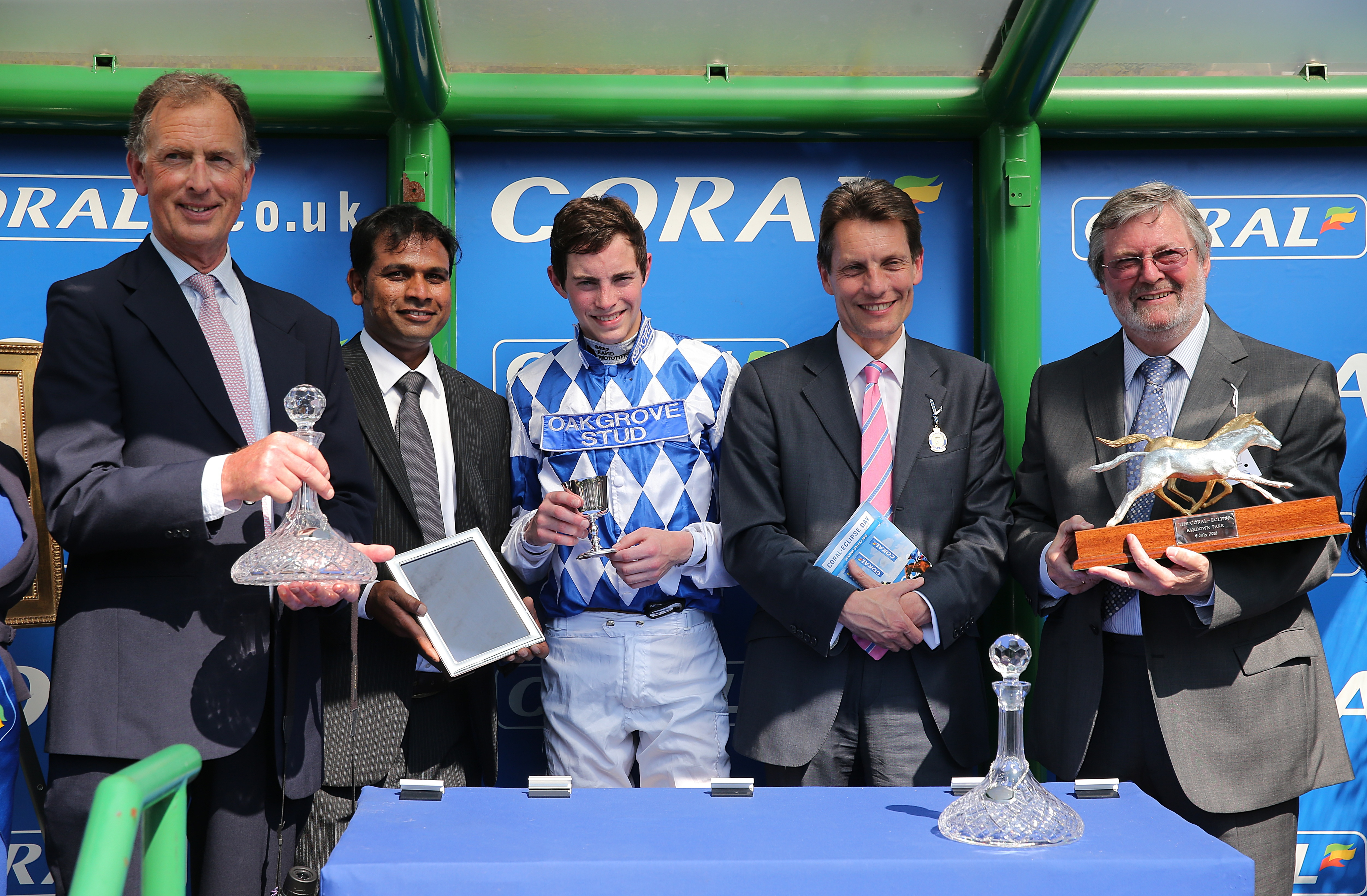 Owner John Deer (right), jockey James Doyle (centre) and trainer Roger Charlton (left) celebrate winning the Coral-Eclipse with Al Kazeem