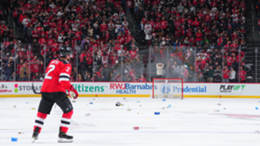 Brendan Smith of the New Jersey Devils looks on as fans throw drinks onto the ice after a disallowed goal for the Devils against the Toronto Maple Leafs