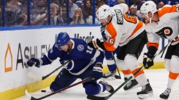 Tampa Bay Lightning winger Corey Perry surrounded by Philadelphia Flyers defenders