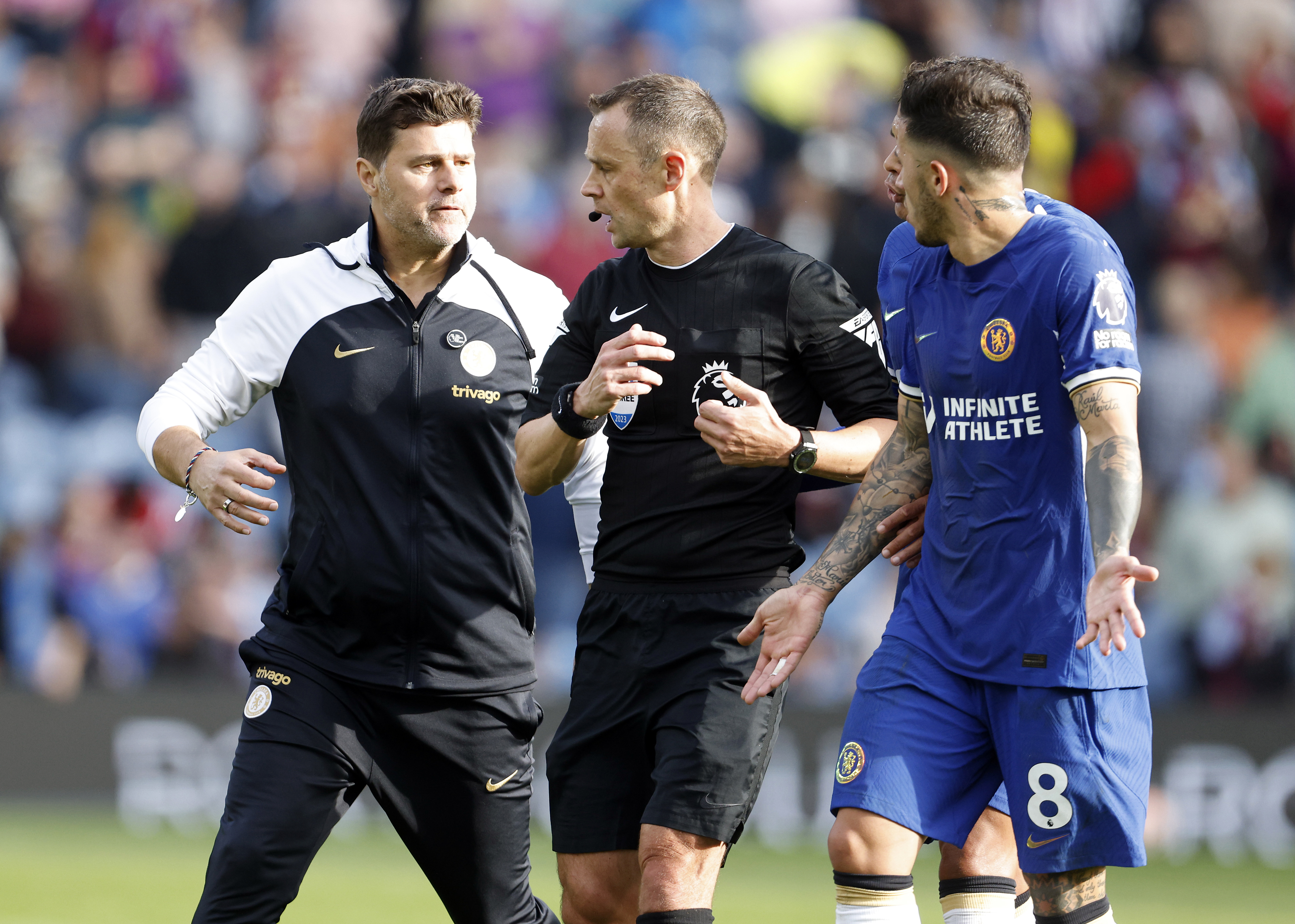 Chelsea manager Mauricio Pochettino speaks to referee Stuart Attwell at half-time during his side's win at Turf Moor