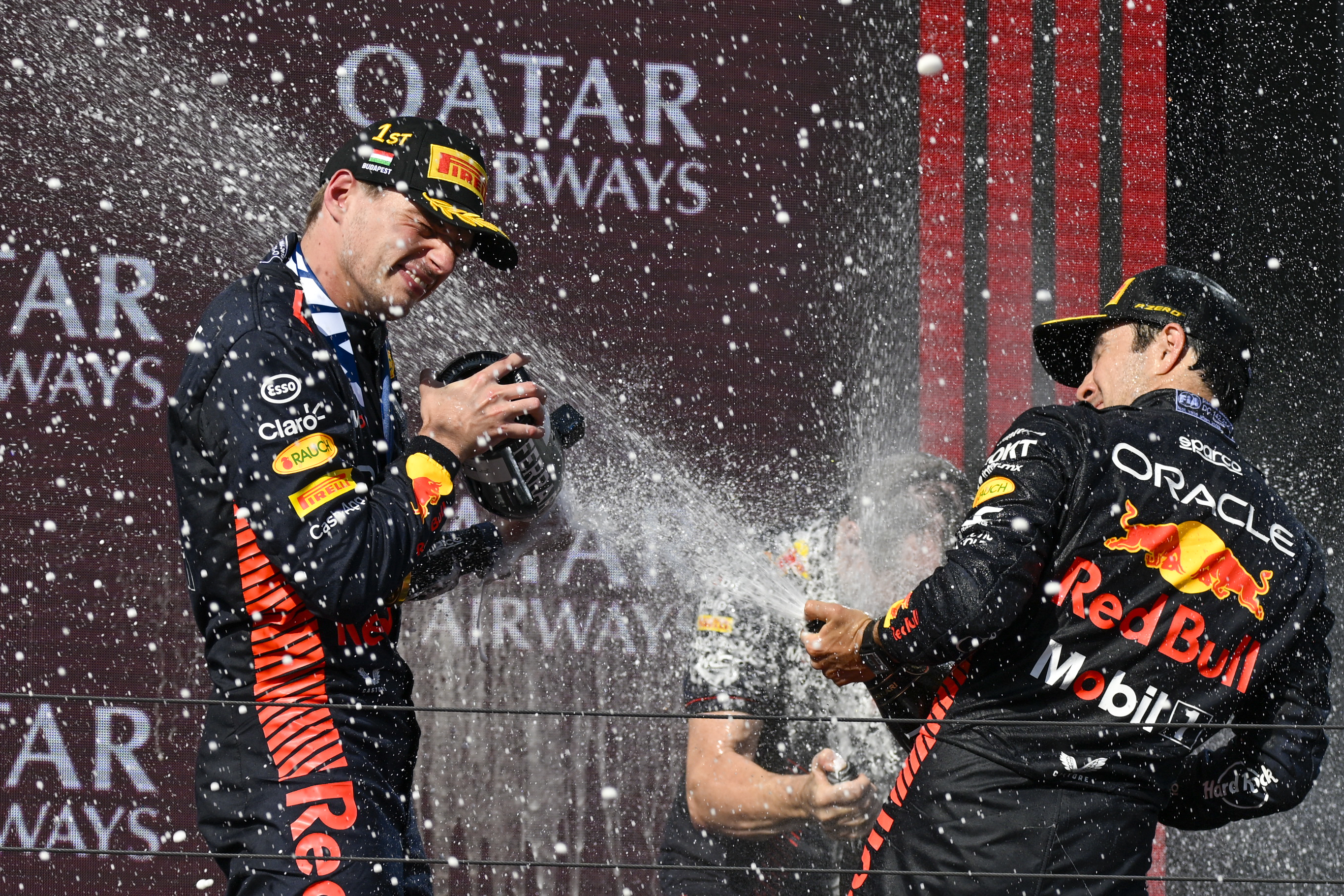 Max Verstappen, left, sprays champagne on the podium with third-placed team-mate Sergio Perez in Hungary