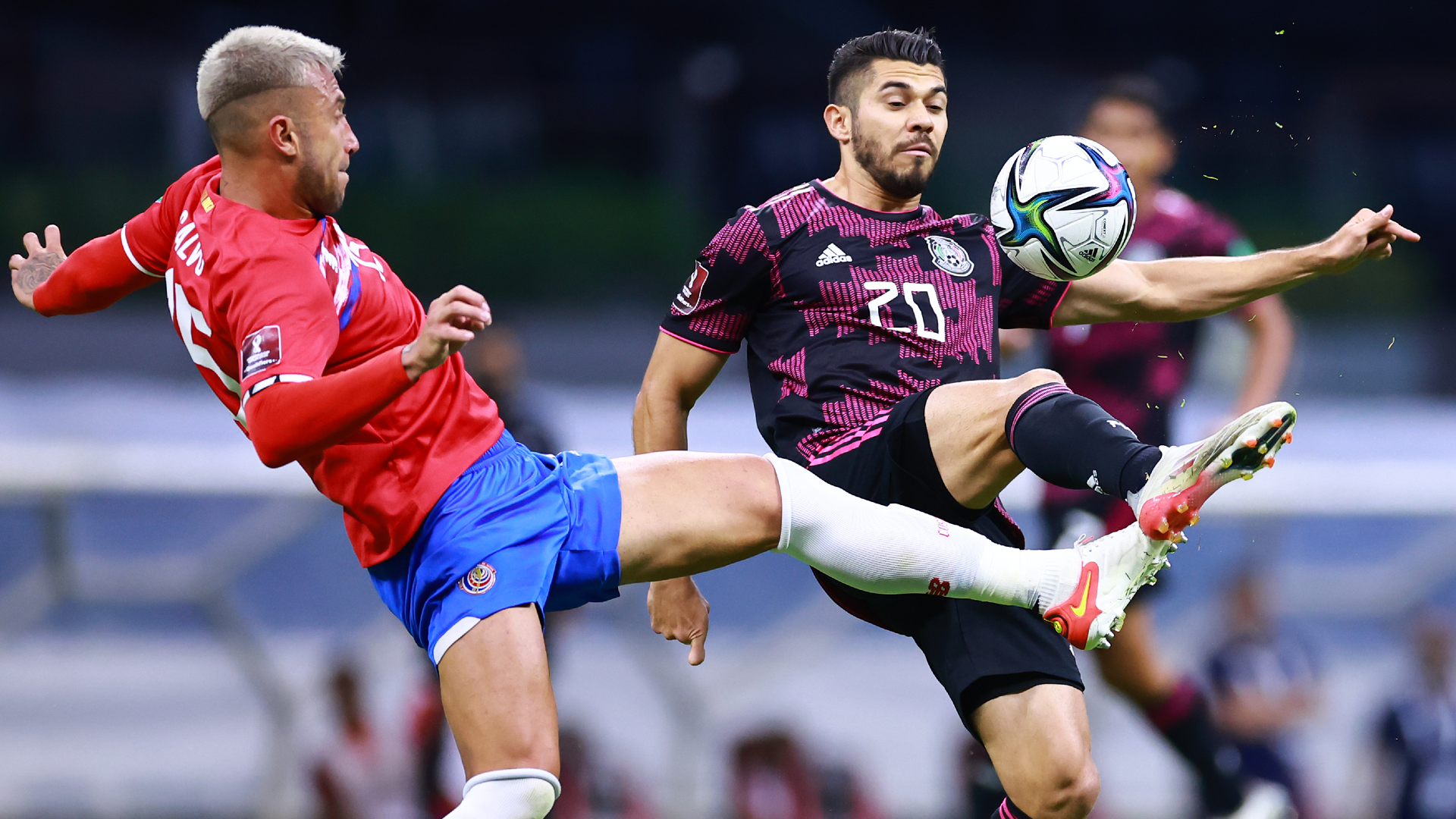 Francisco Calvo of Costa Rica competes for the ball with Henry Martin of Mexico