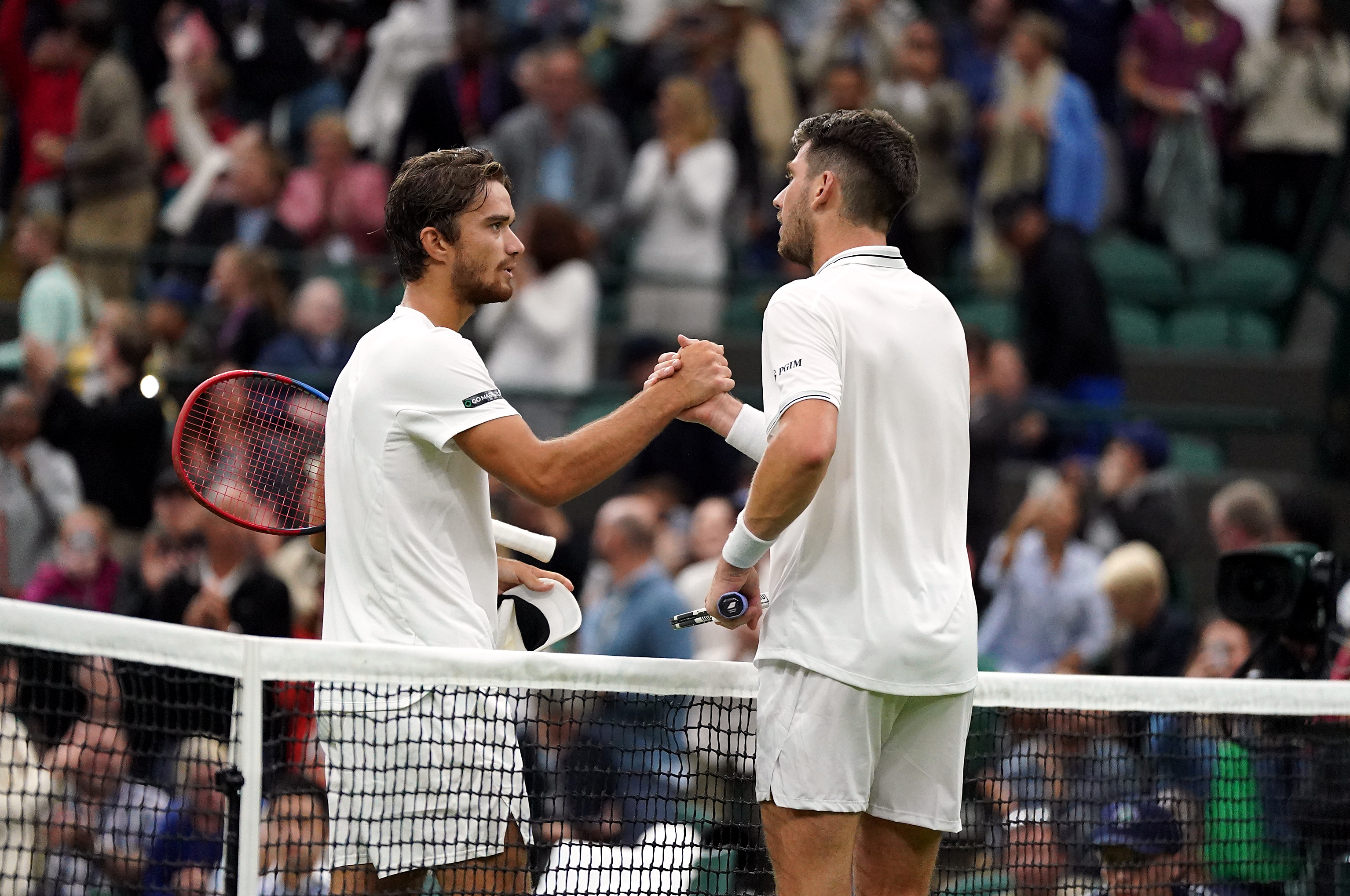 Cameron Norrie (right) and Tomas Machac shake hands at the net