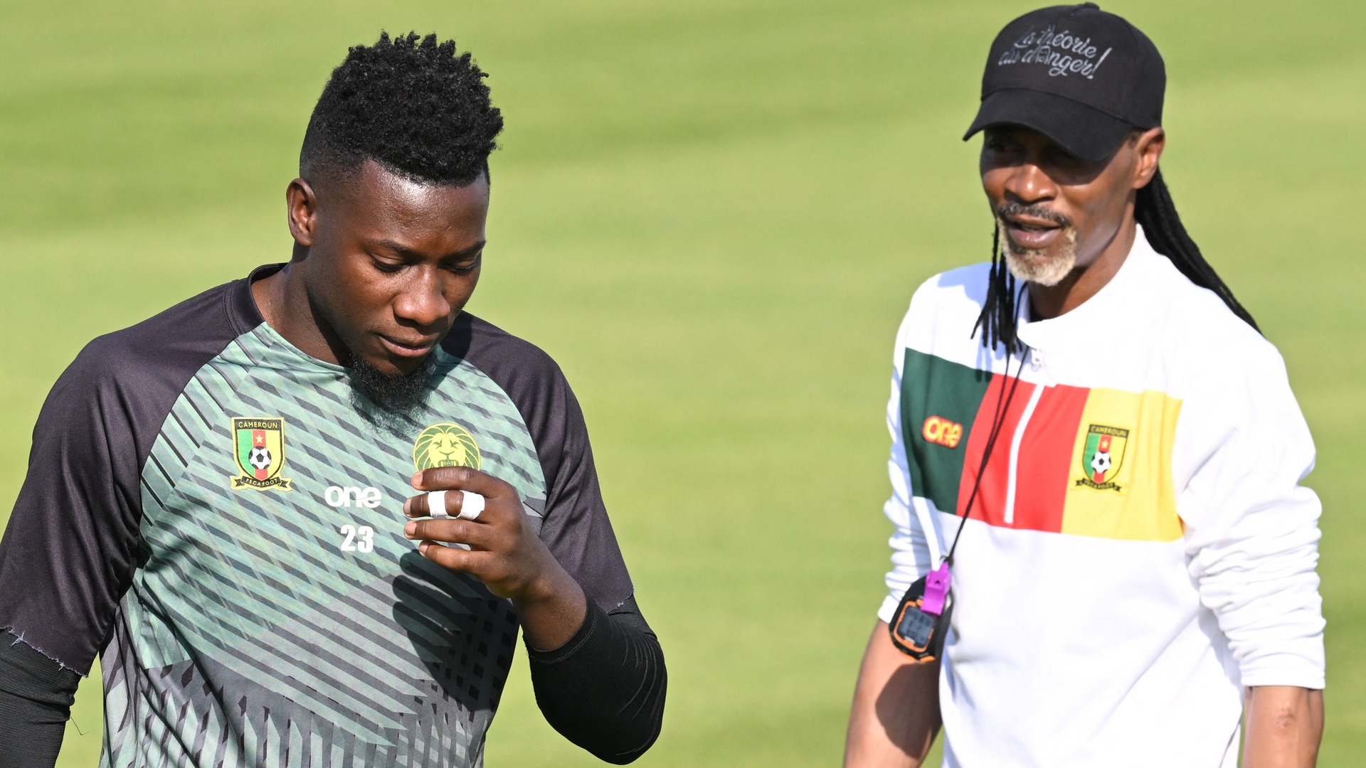 Andre Onana (L) is spoken to by Rigobert Song at training before being suspended by Cameroon
