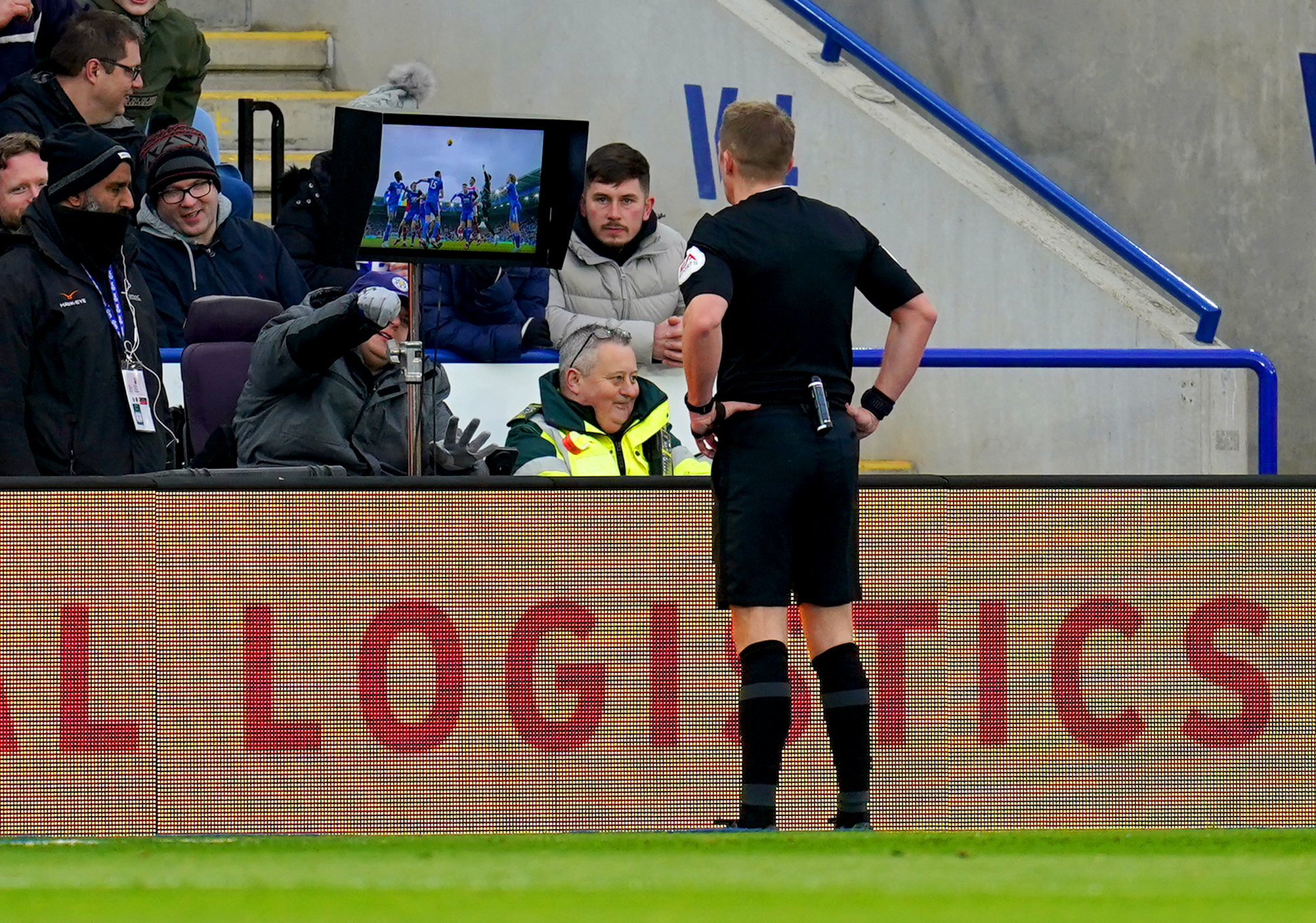 Referee Craig Pawson checks the pitchside VAR monitor