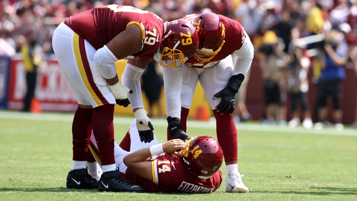 Ryan Fitzpatrick (centre) was injured during Washington Football Team's clash with the Los Angeles Chargers