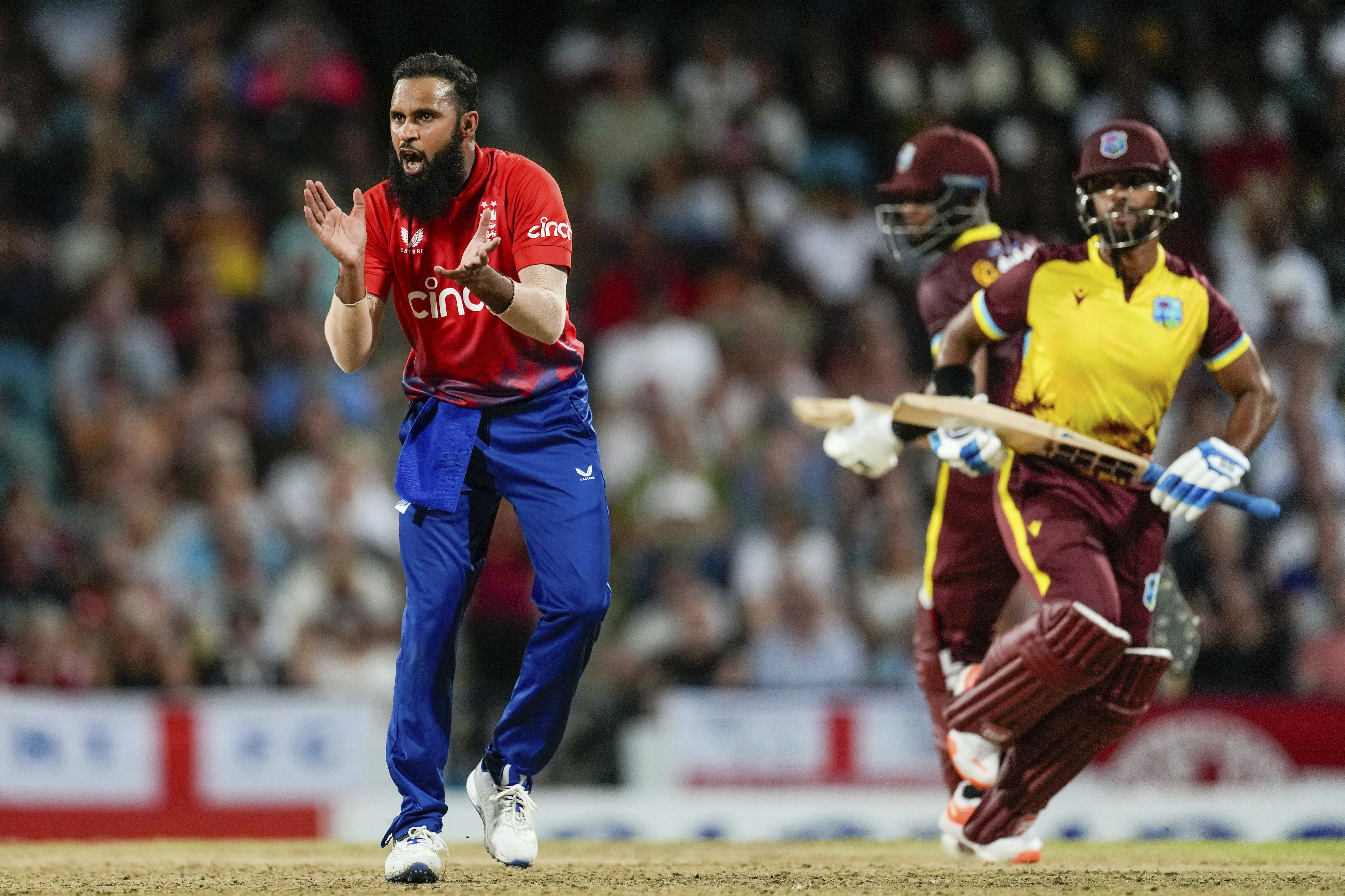 Adil Rashid (left) in action for England