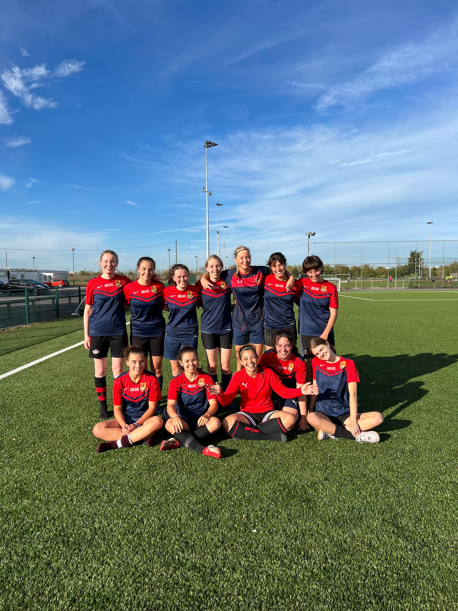 Players at Imperial College London women's football team standing together on the pitch