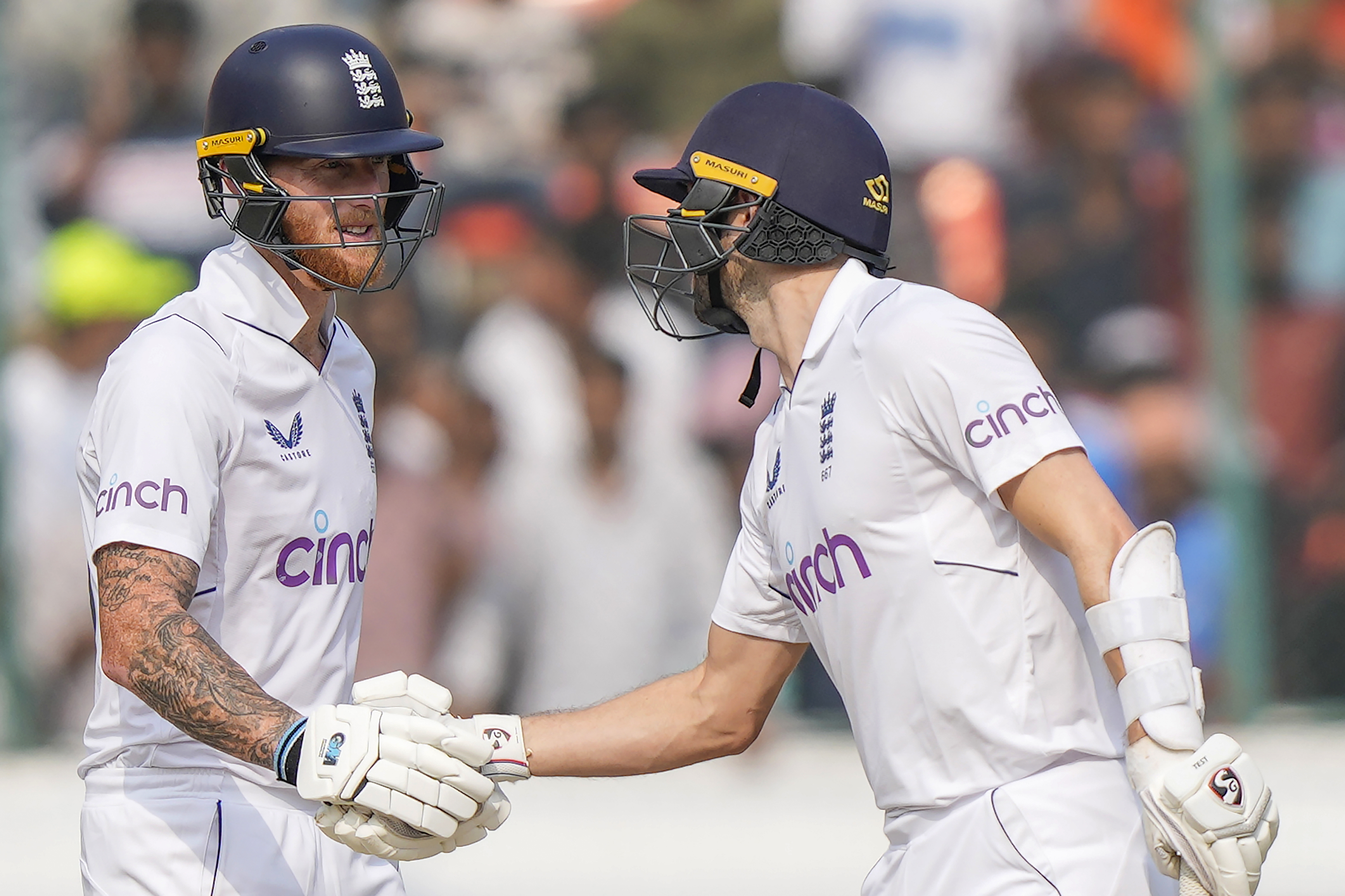 Stokes, left, celebrates his fifty with Wood