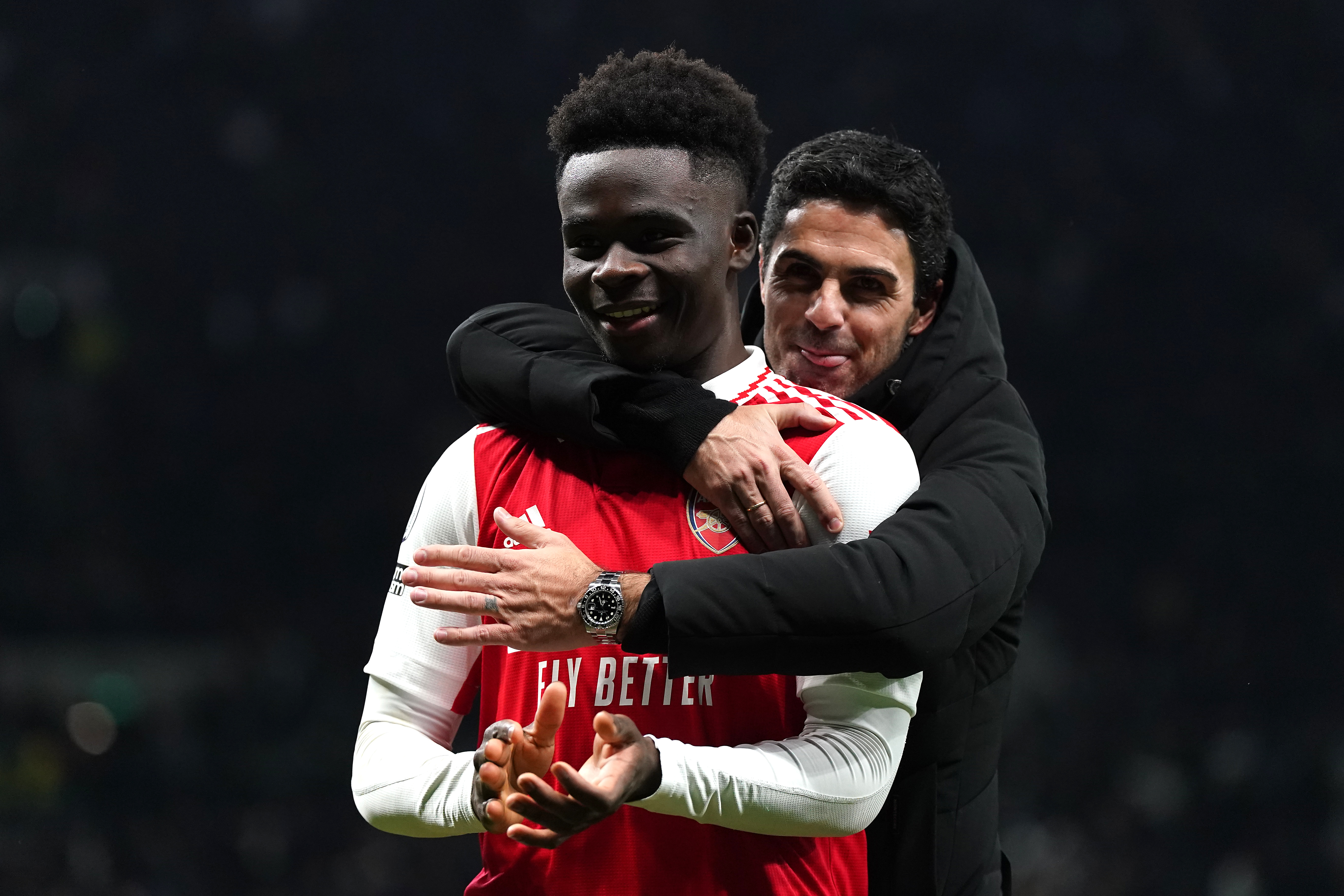 Arsenal’s Bukayo Saka celebrates with manager Mikel Arteta