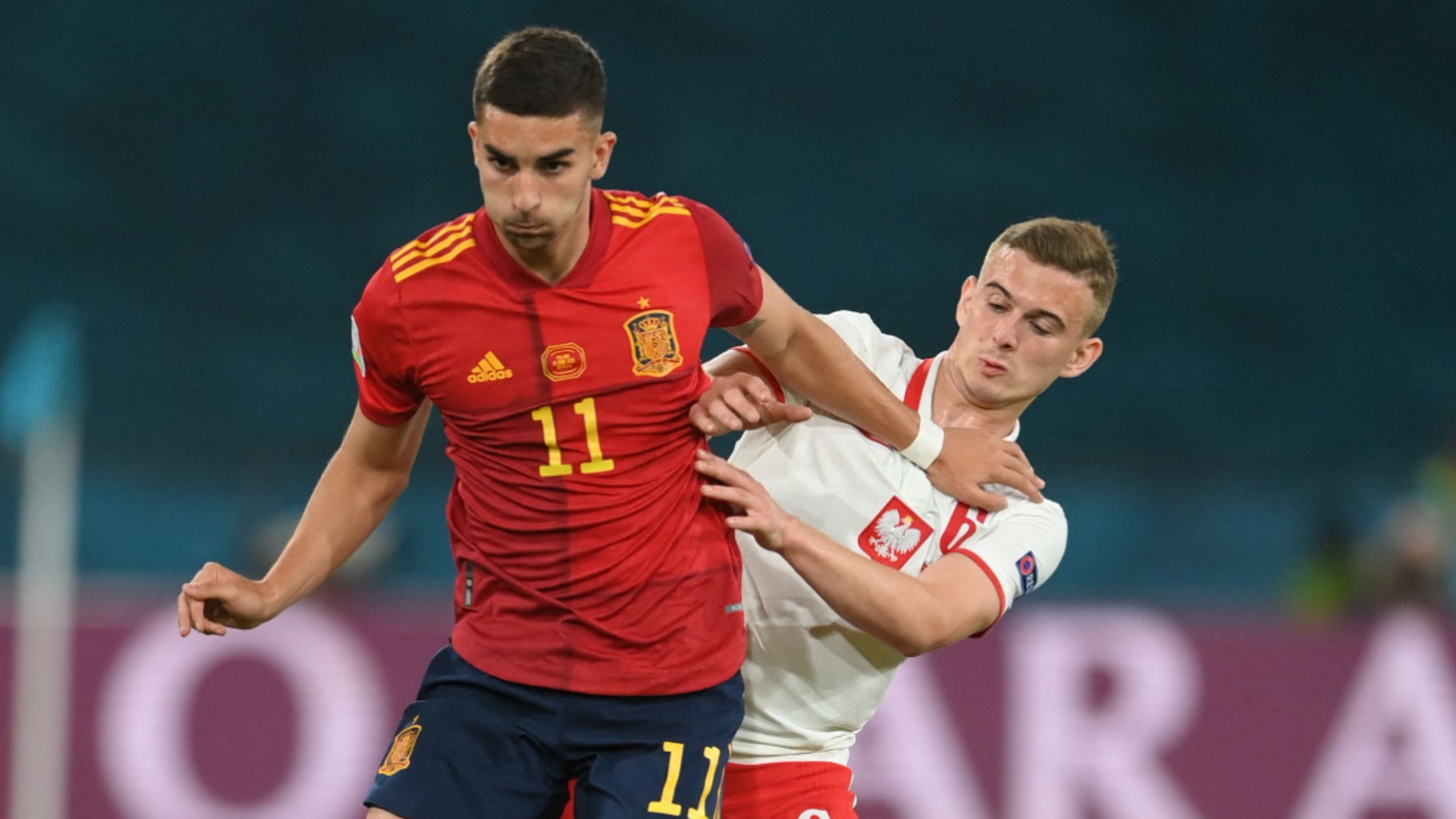 Kacper Kozlowski (right) challenges Ferran Torres
