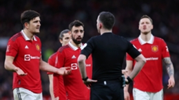 Manchester United players protest a decision made by referee Chris Kavanagh in the FA Cup quarter-finals against Fulham