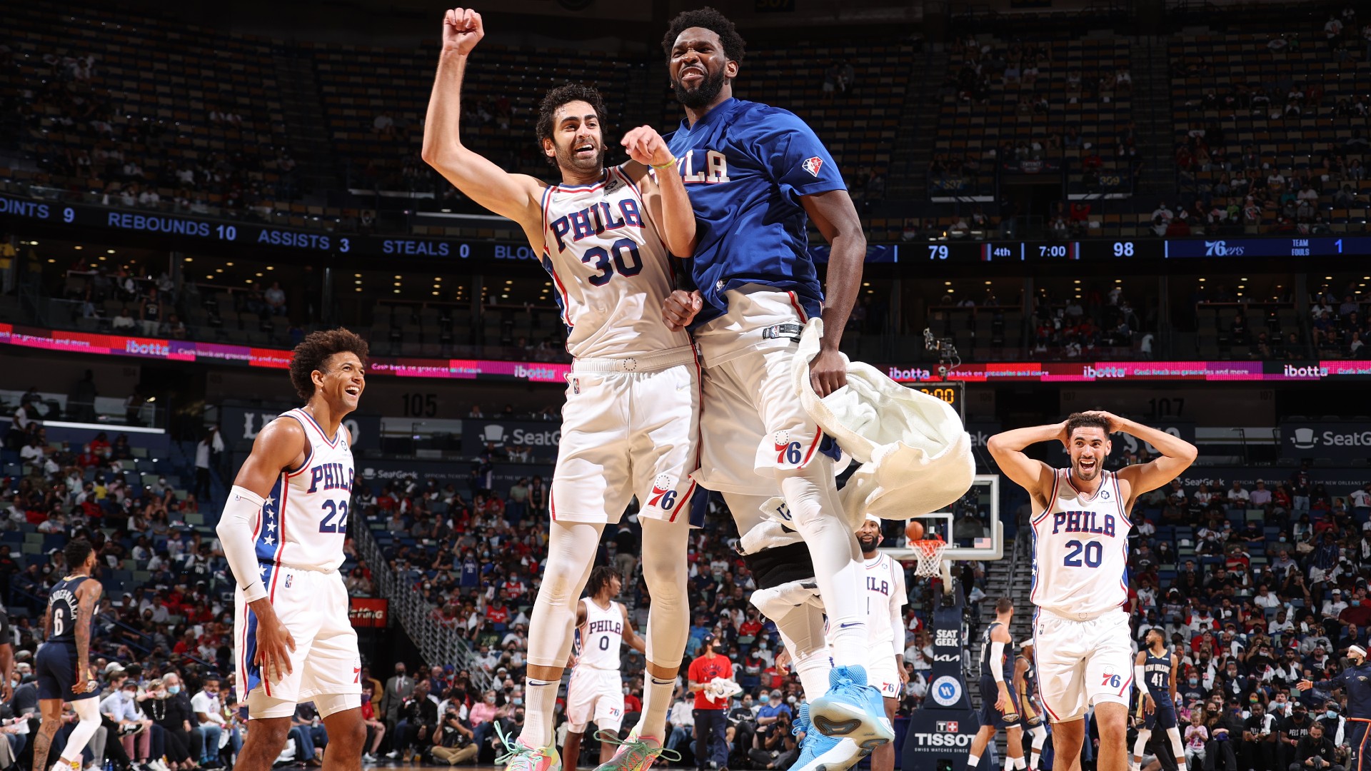 Joel Embiid (R) and the Philadelphia 76ers celebrate on opening night