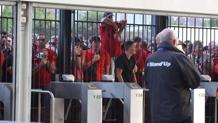 Liverpool fans queue outside the Stade de France during chaotic scenes before the Champions League final