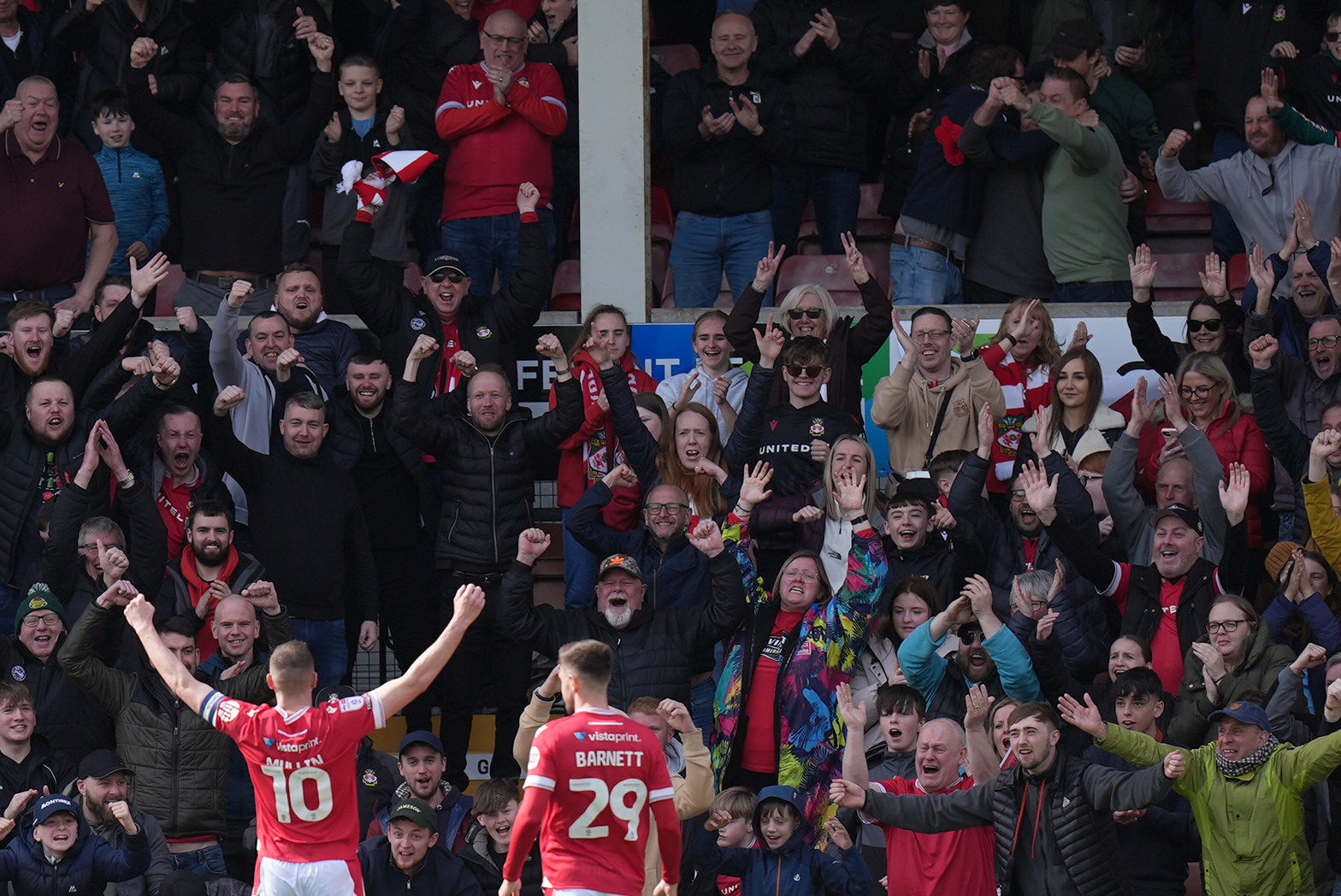 Wrexham’s Paul Mullin (left) celebrates in front of the fans