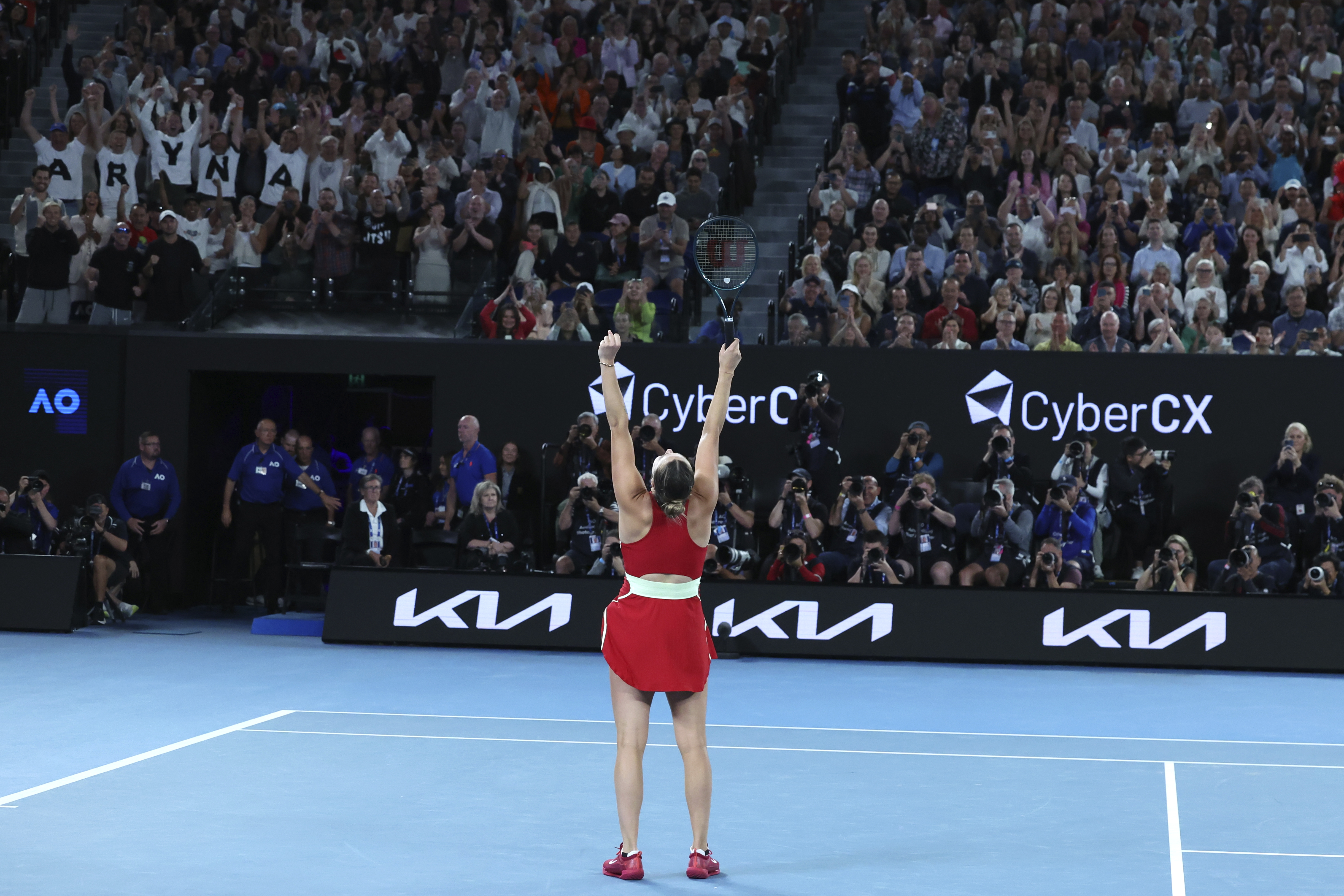 Aryna Sabalenka thrusts her arms into the air after beating Zheng Qinwen in the final